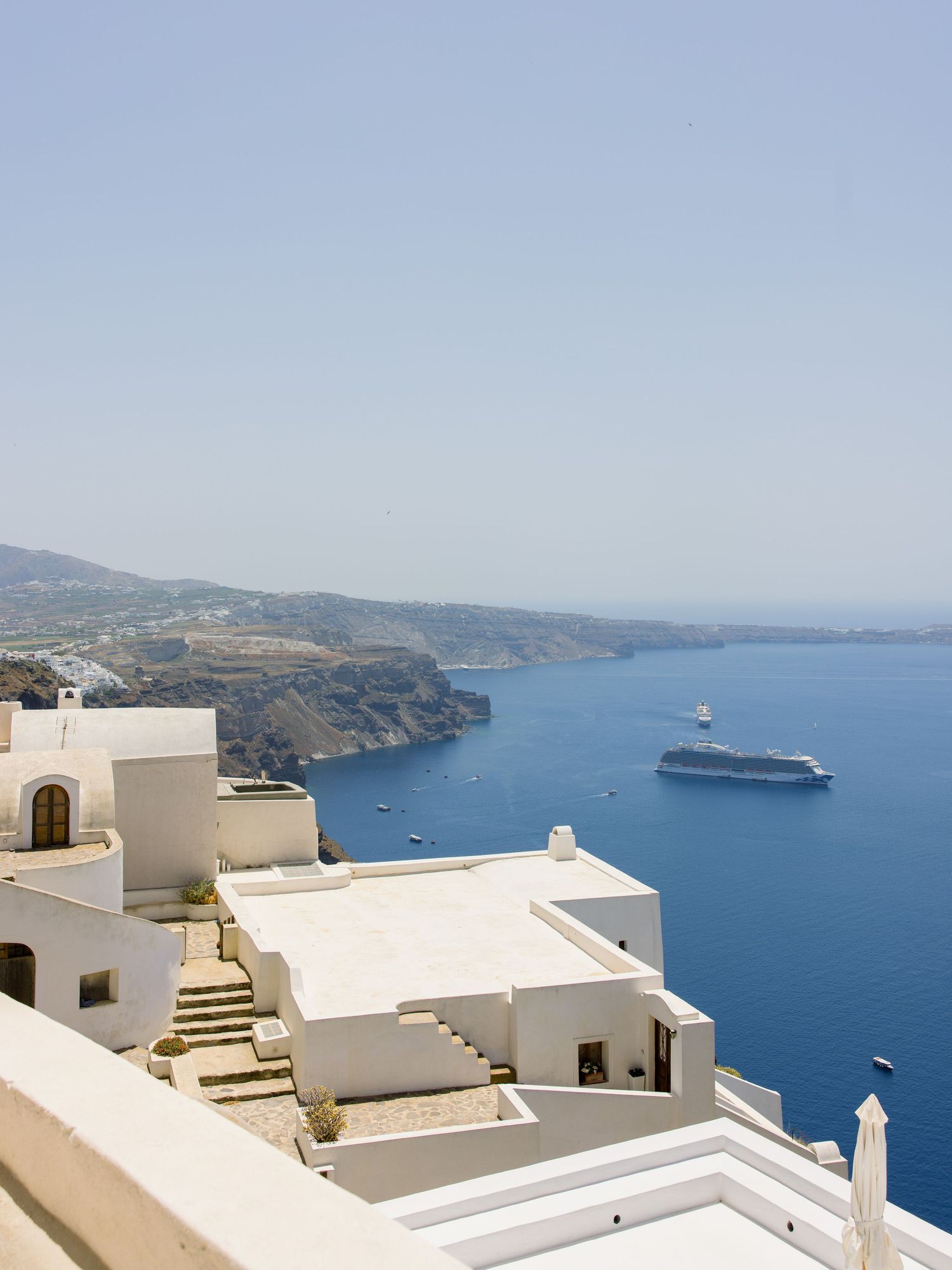 White buildings and terraces overlooking the blue Aegean Sea in Santorini.