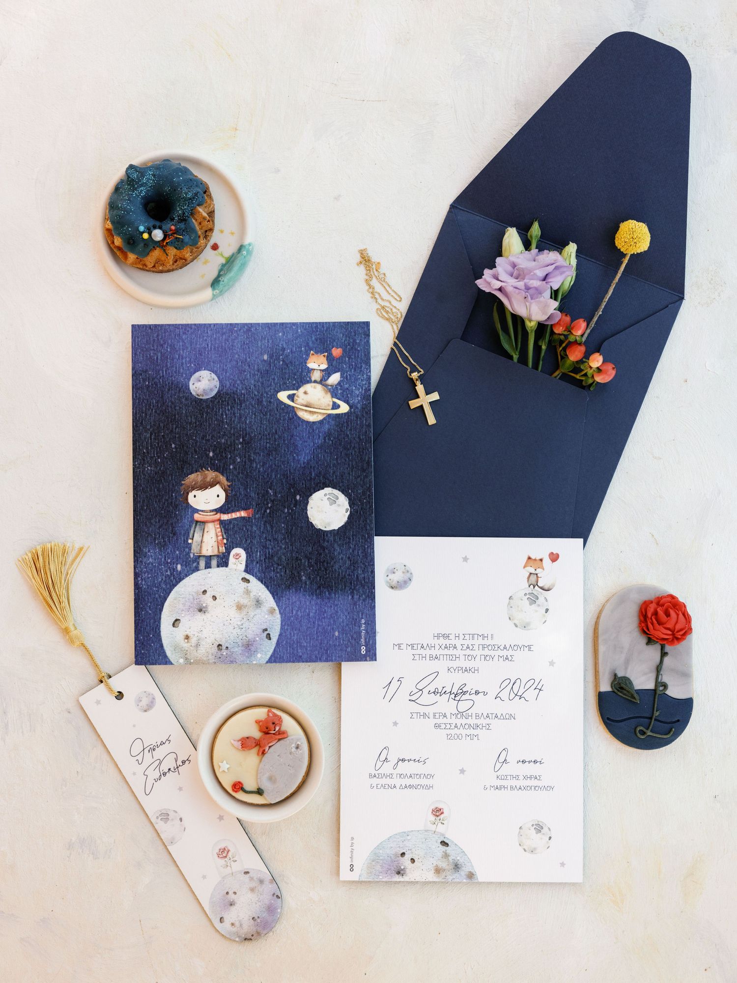 Whimsical wedding invitation suite featuring navy blue envelopes and delicate celestial illustrations with moon and stars.