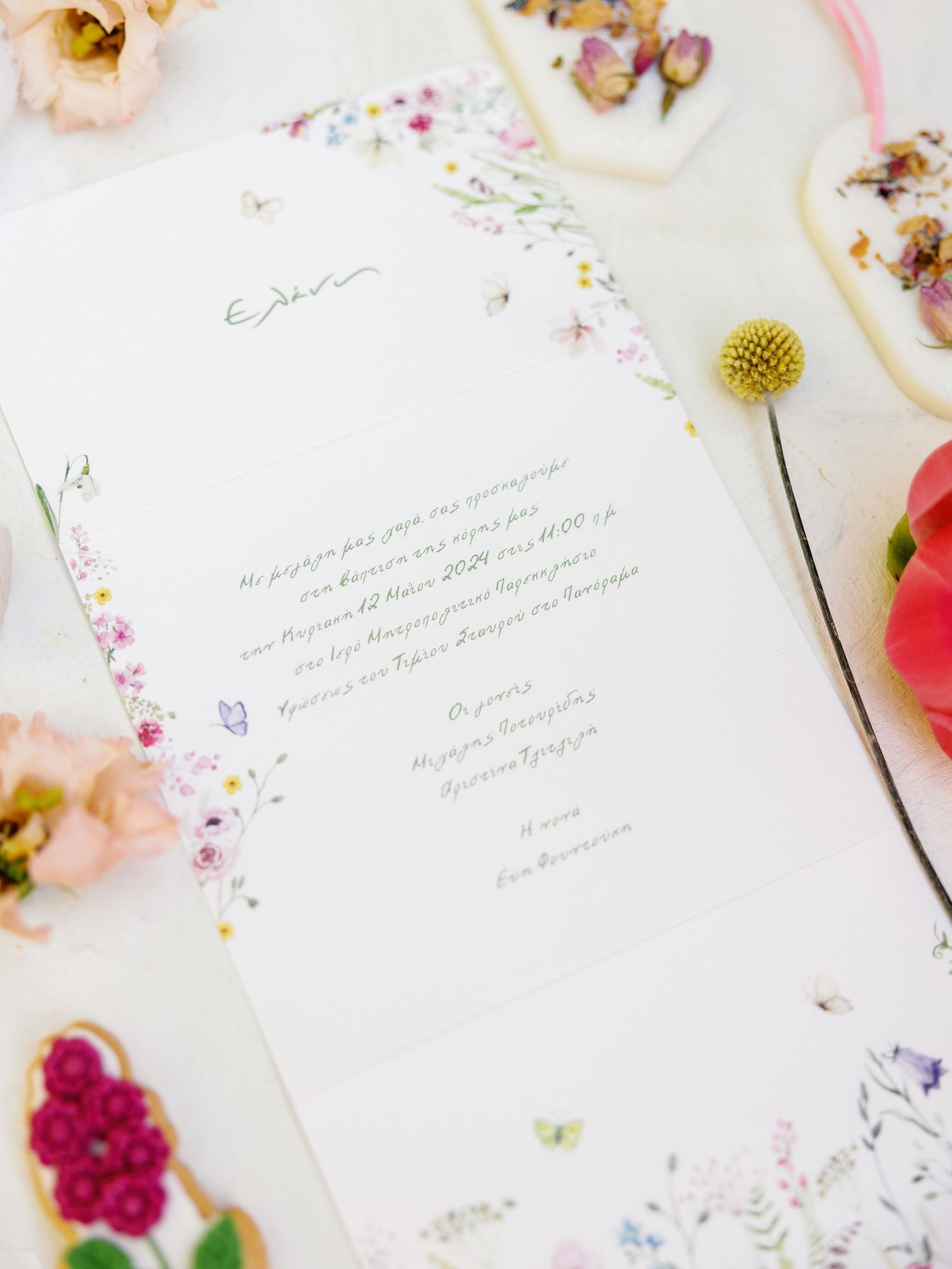 Elegant wedding invitation stationery with delicate floral details and calligraphy text on a light background.
