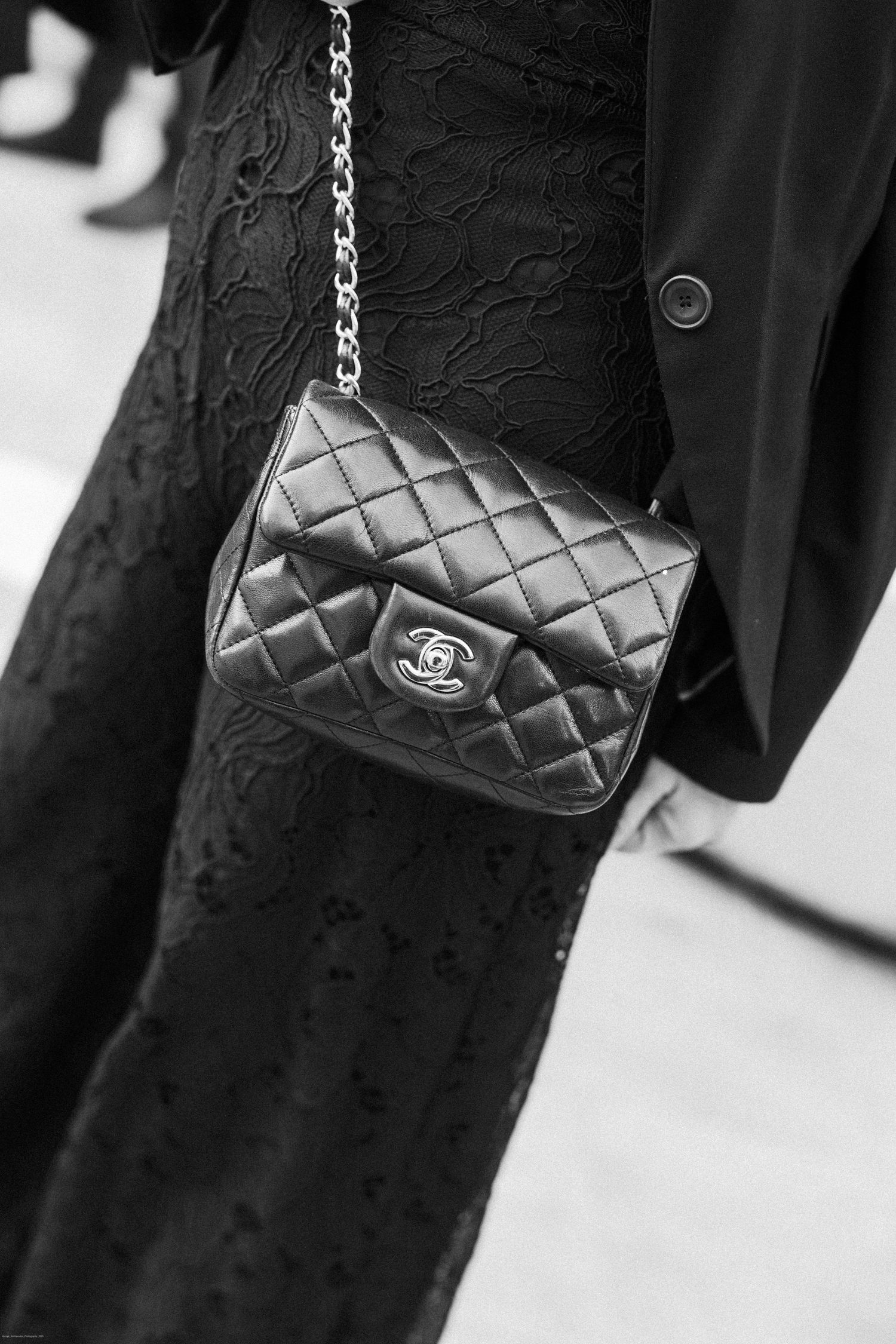 Classic quilted Chanel handbag on chain strap shown in elegant black and white detail.
