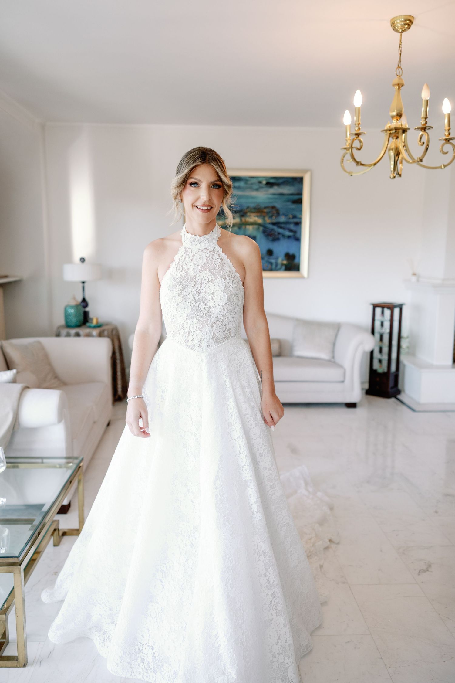Full-length view of a princess ballgown wedding dress in an elegant white room.