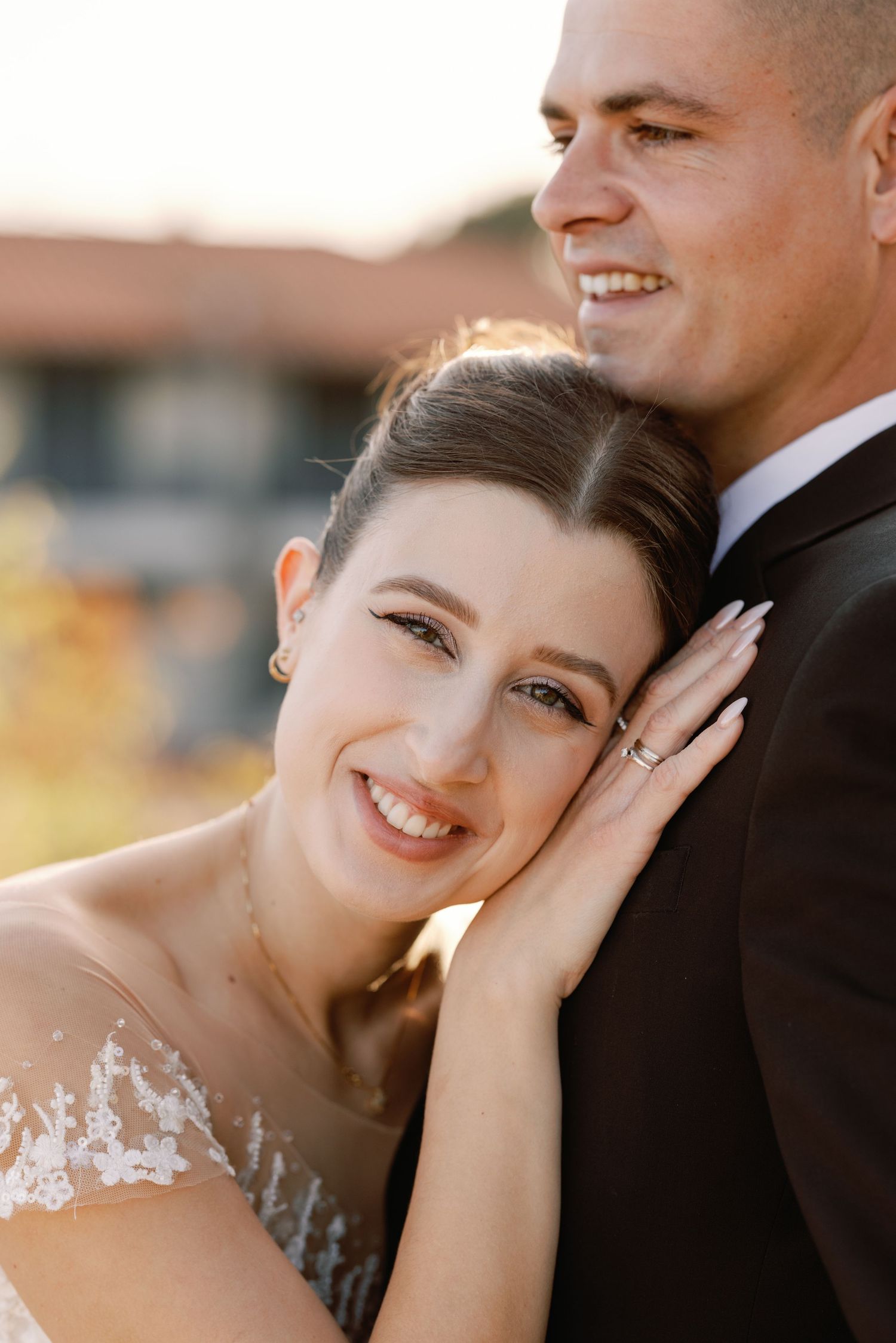 Intimate sunset wedding portraits capturing joyful moments between newlyweds.