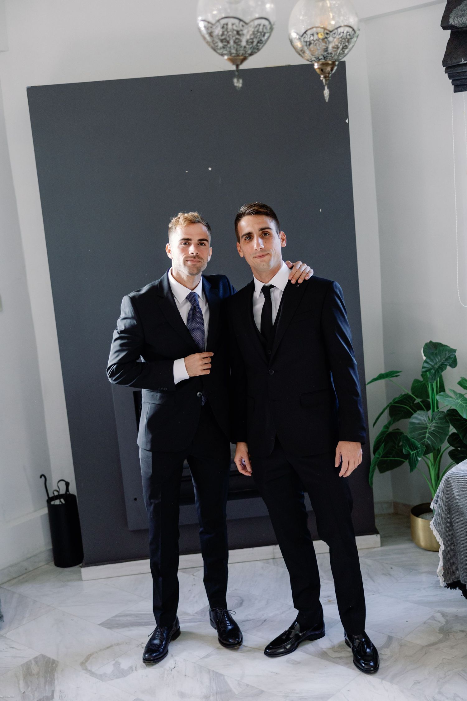 Formal event preparation with people in black suits and ties.