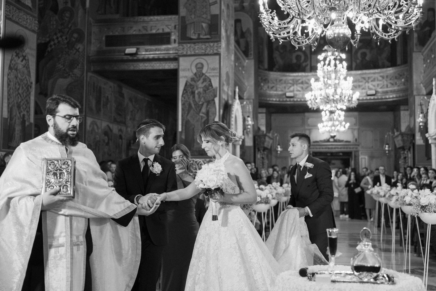Wedding celebration in elegant venue with crystal chandeliers and formal decor.