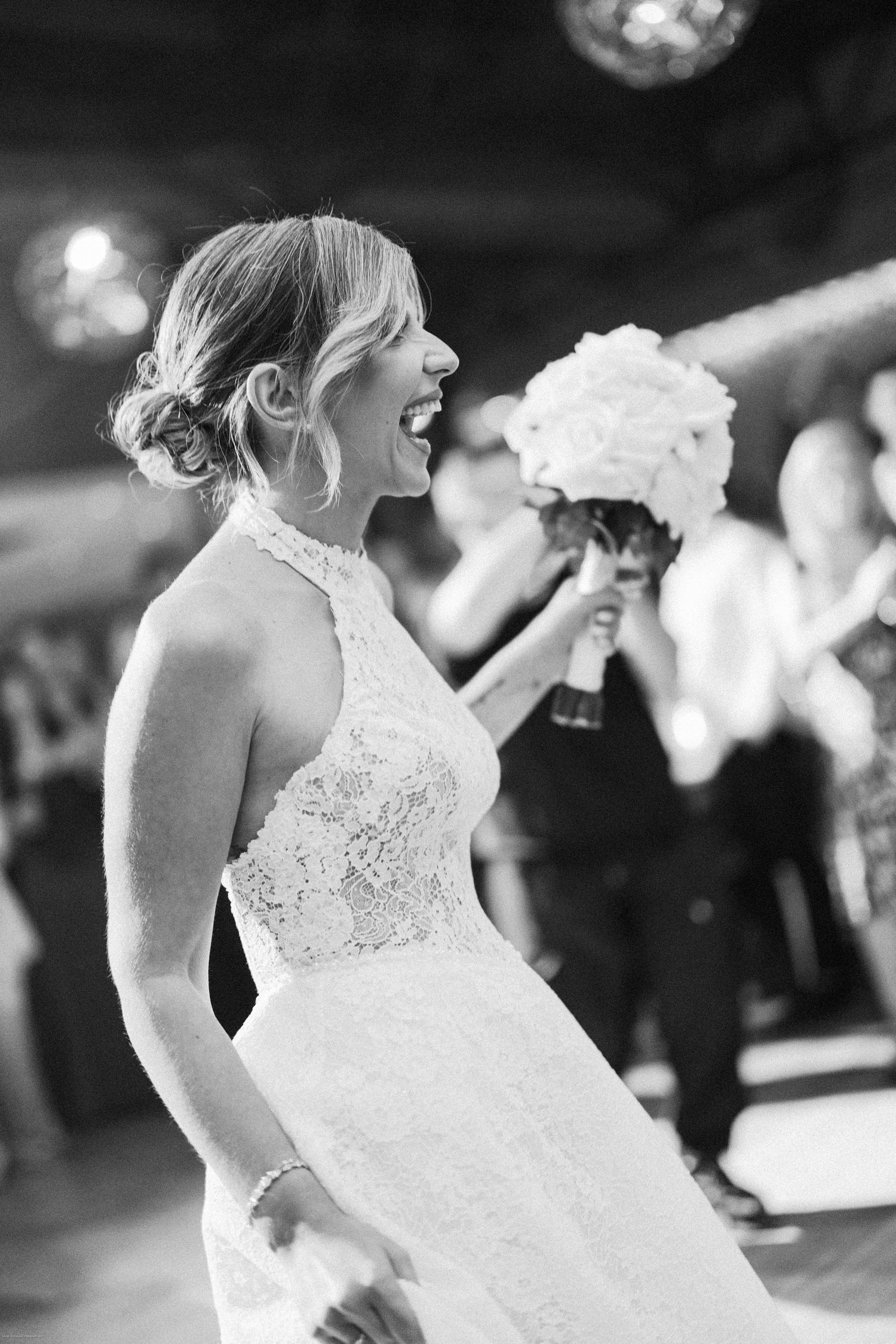 A series of black and white photos showing a bride in a lace wedding dress dancing at a reception.