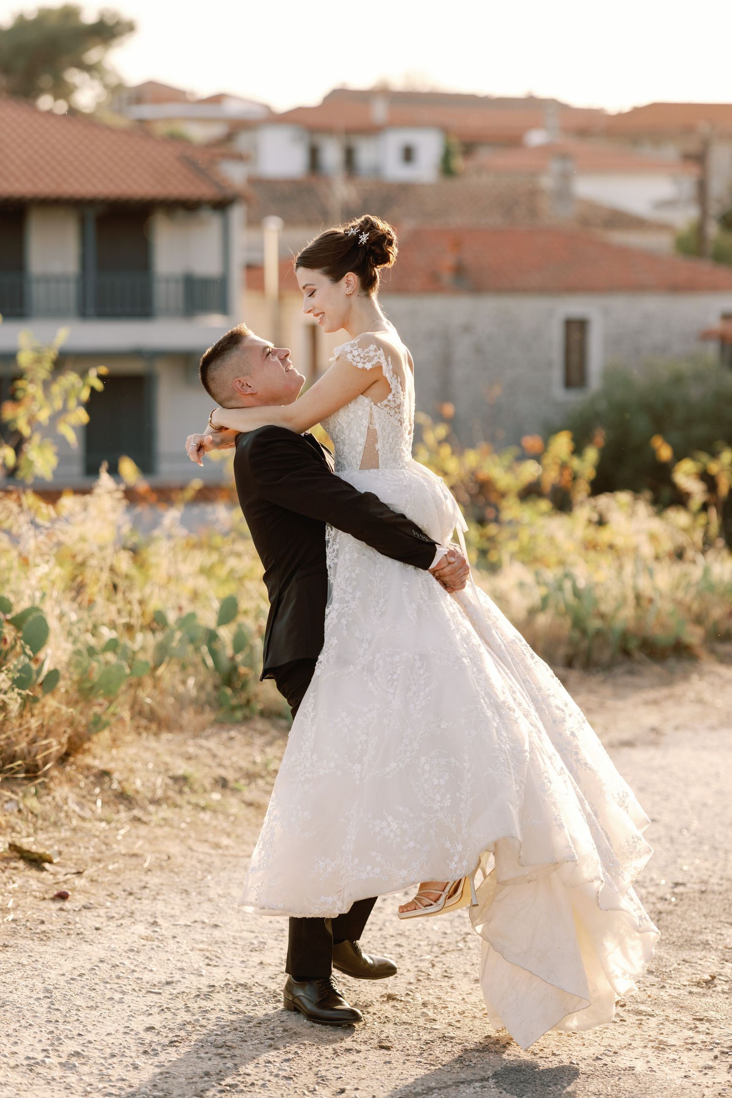 Romantic sunset wedding portraits with couple dancing in golden light.