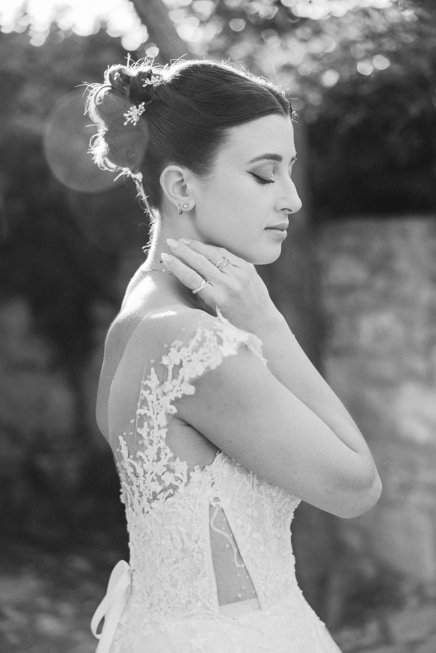 Black and white bridal portraits showcasing intricate lace details of a wedding dress.