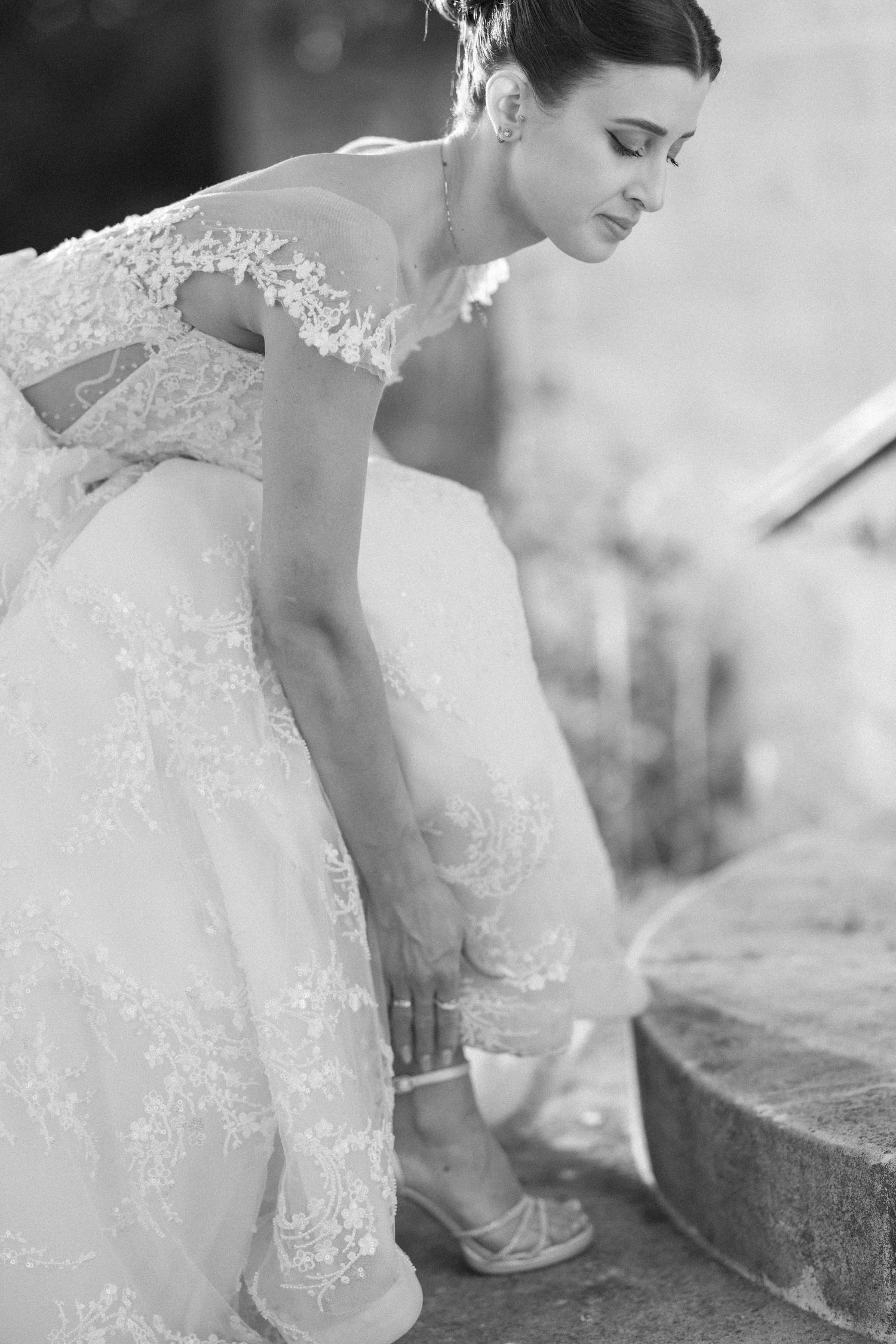 Close-up details of a delicate lace wedding dress with intricate embroidery patterns.