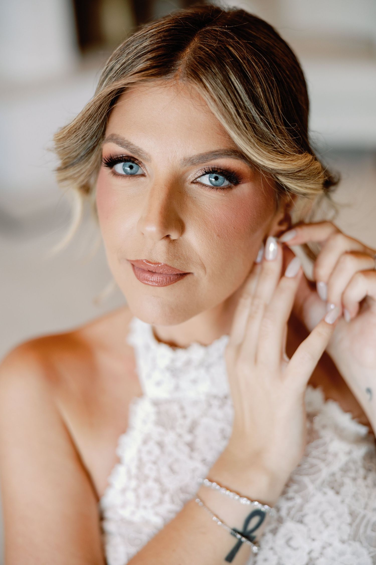 Close-up bridal portrait showcasing elegant makeup and sparkling earrings.