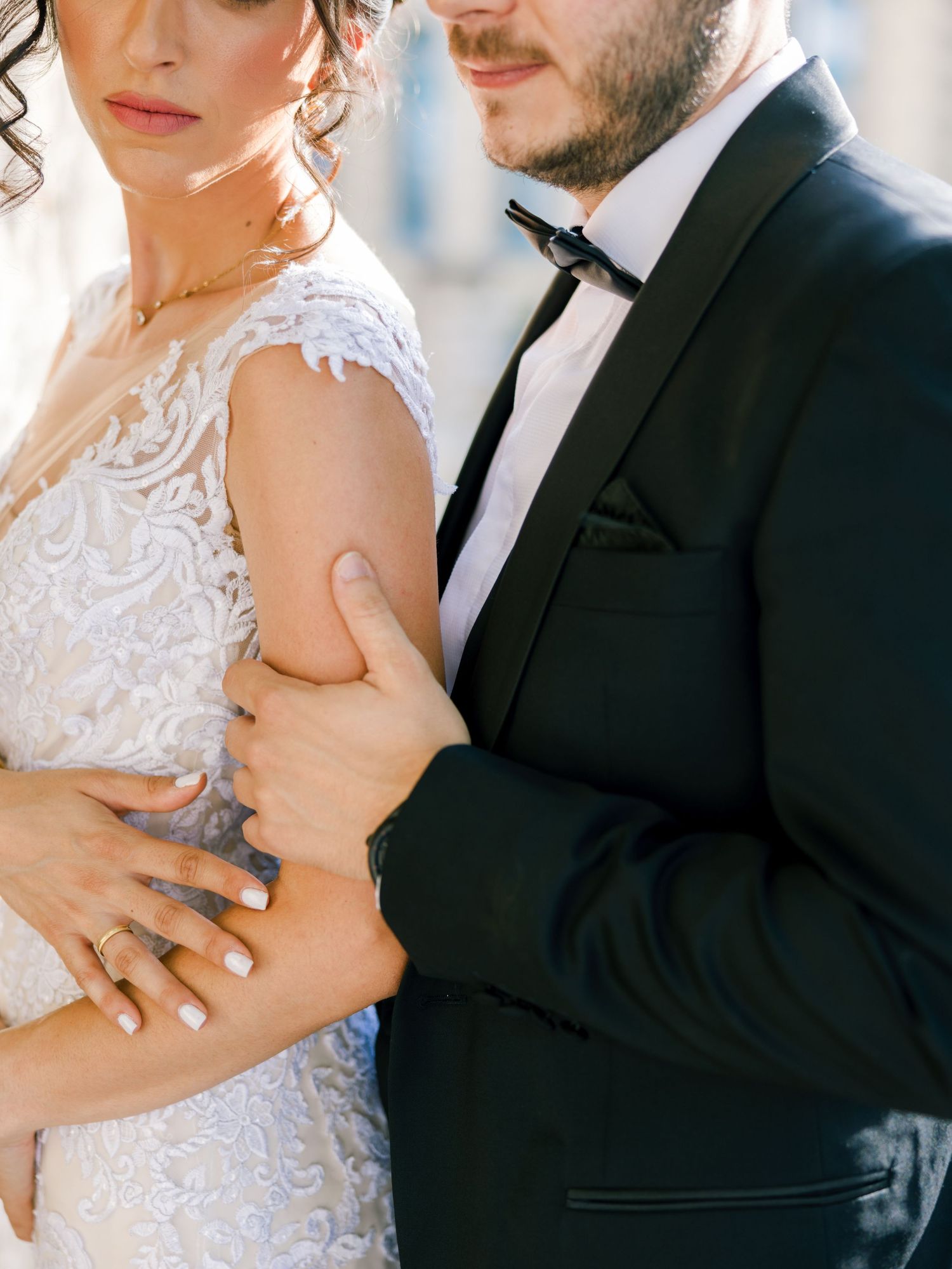 Intimate wedding portrait highlighting delicate lace details and formal attire.