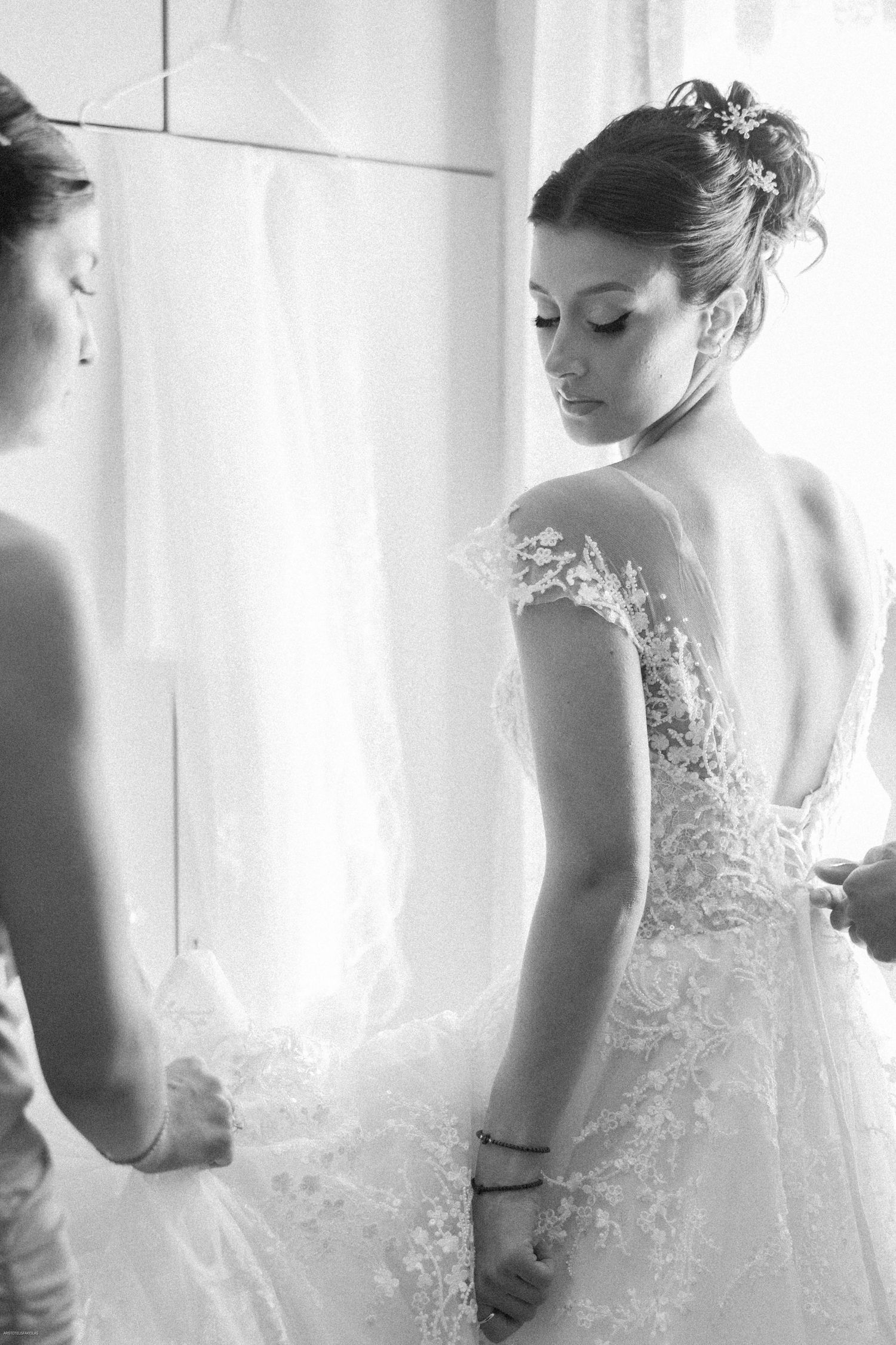 Artistic black and white photos showing details of a lace wedding dress.