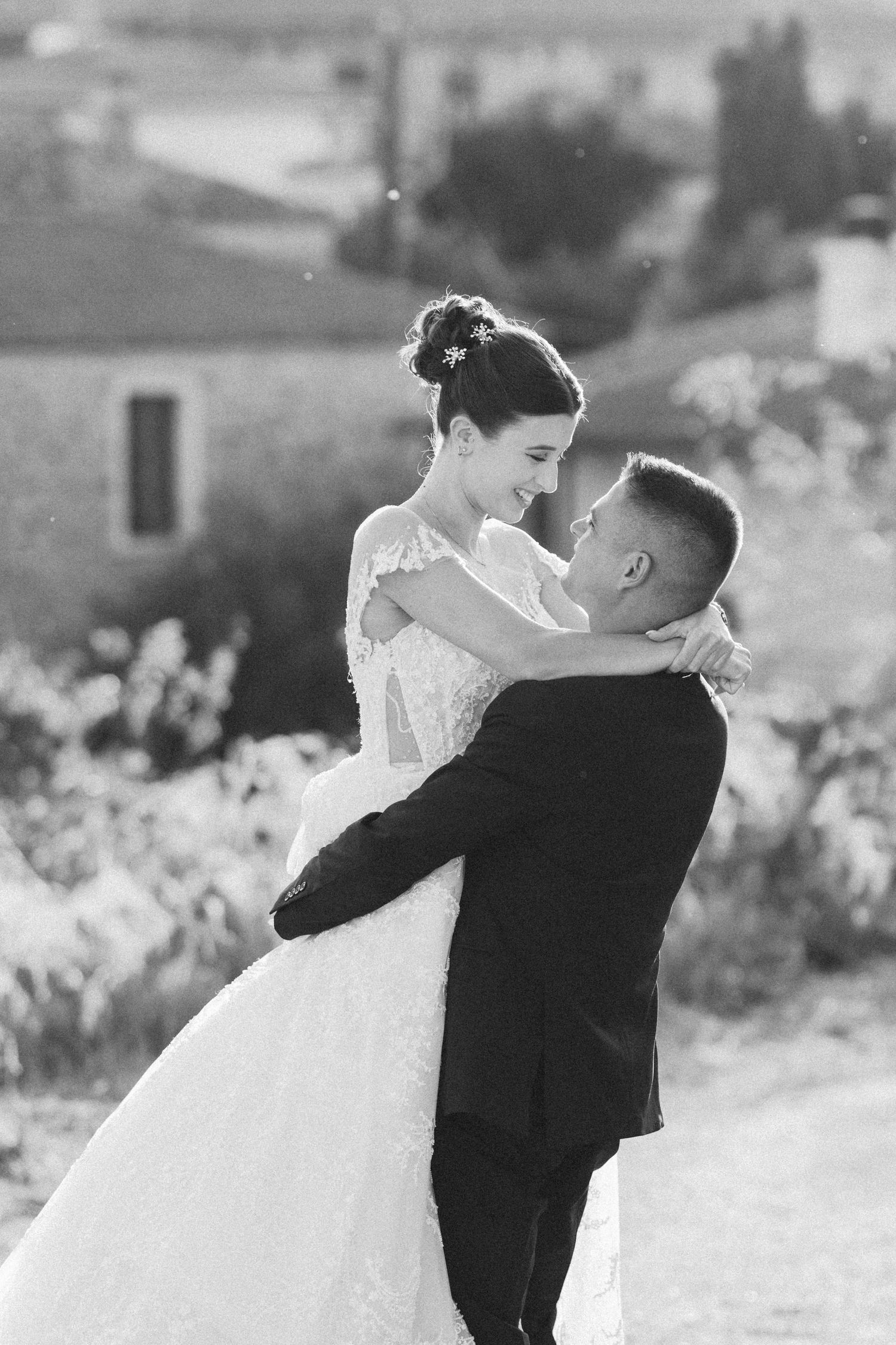 Black and white photo sequence of a romantic wedding couple dancing together outdoors.