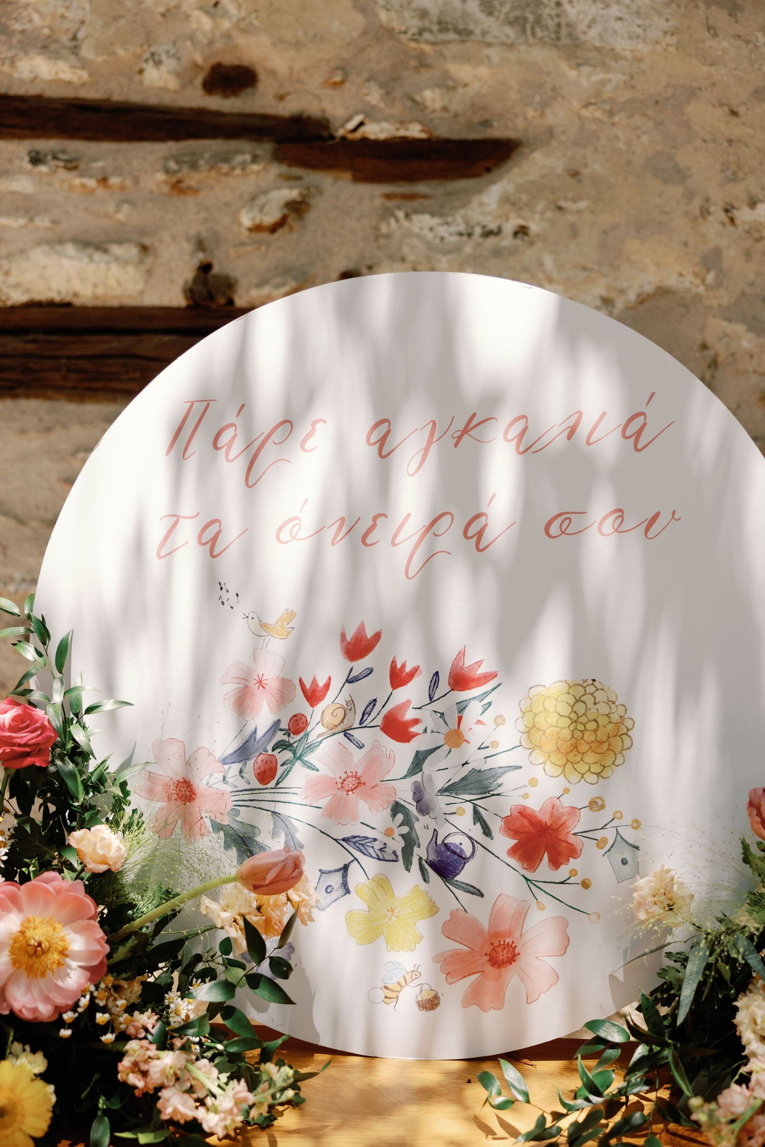 Decorative floral artwork with pink and yellow blooms alongside elegant calligraphy text on white paper.