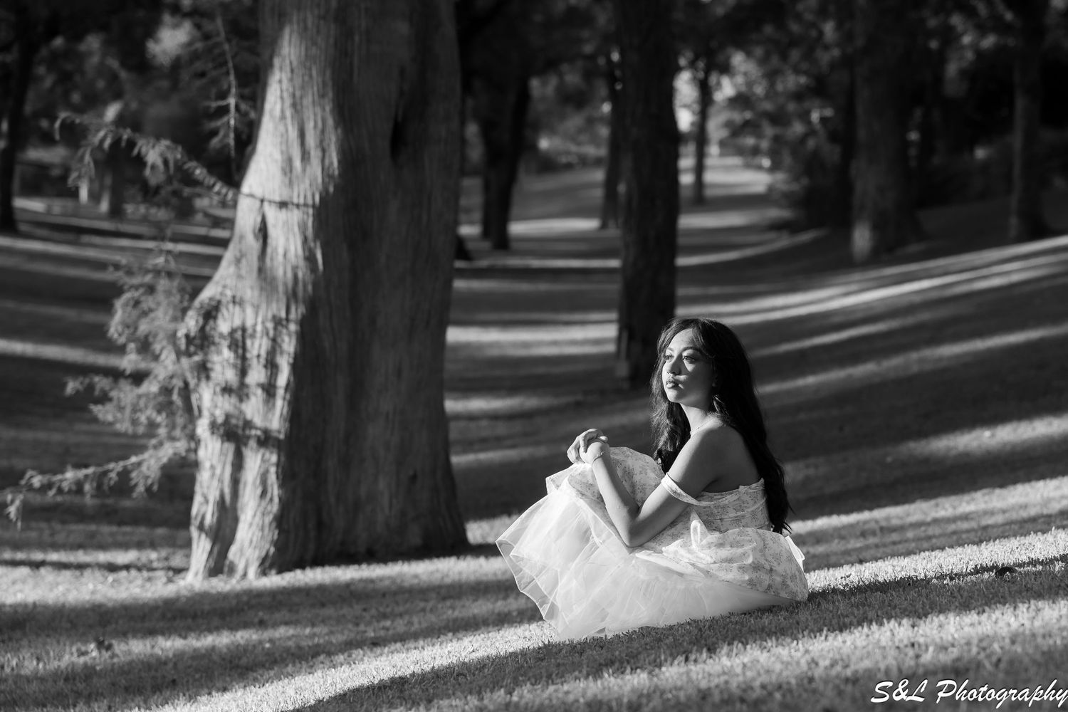 Black and white series of outdoor portraits taken in a park setting with natural lighting.