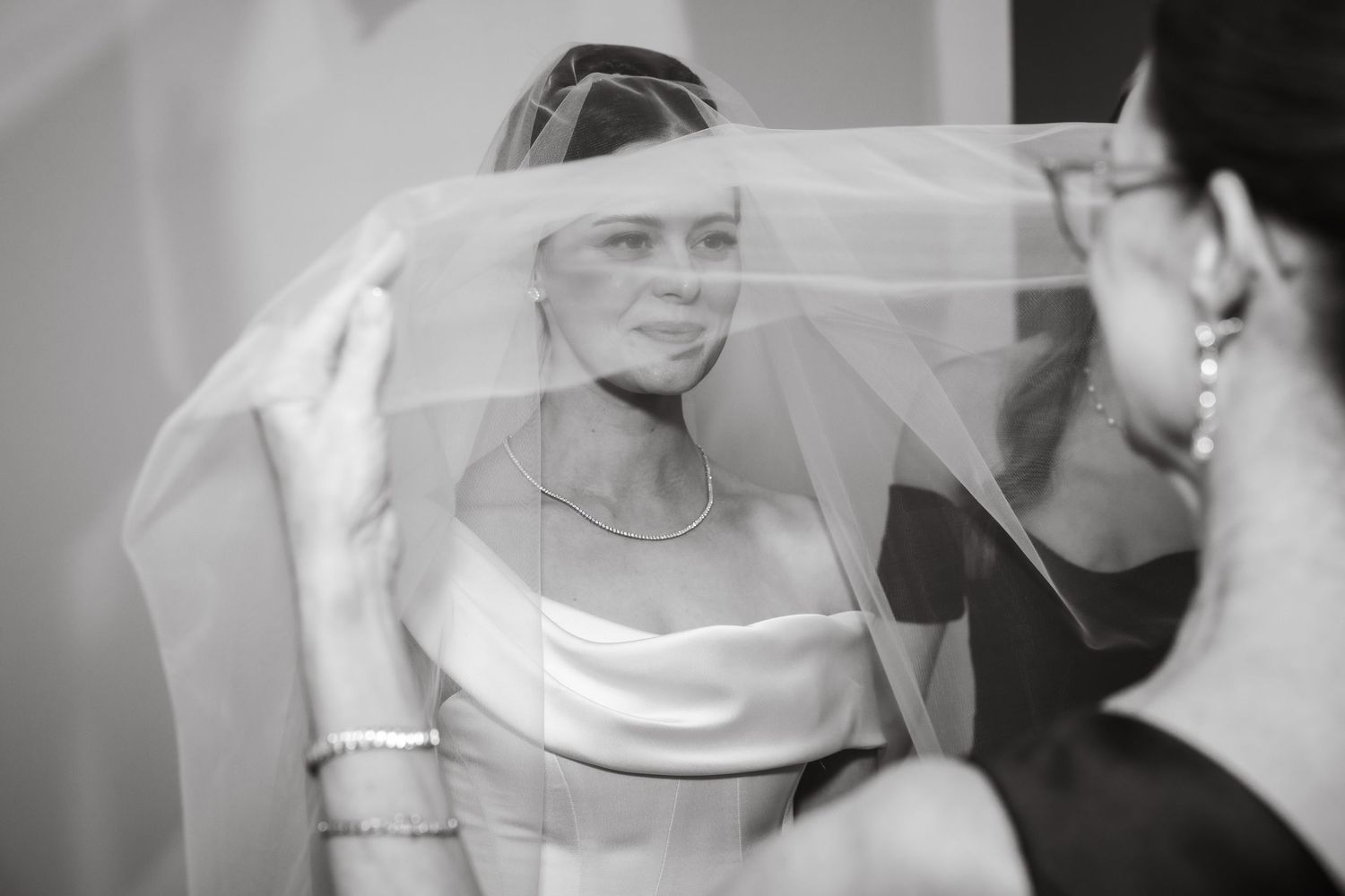 Artistic black and white sequence of bridal veil adjustments.