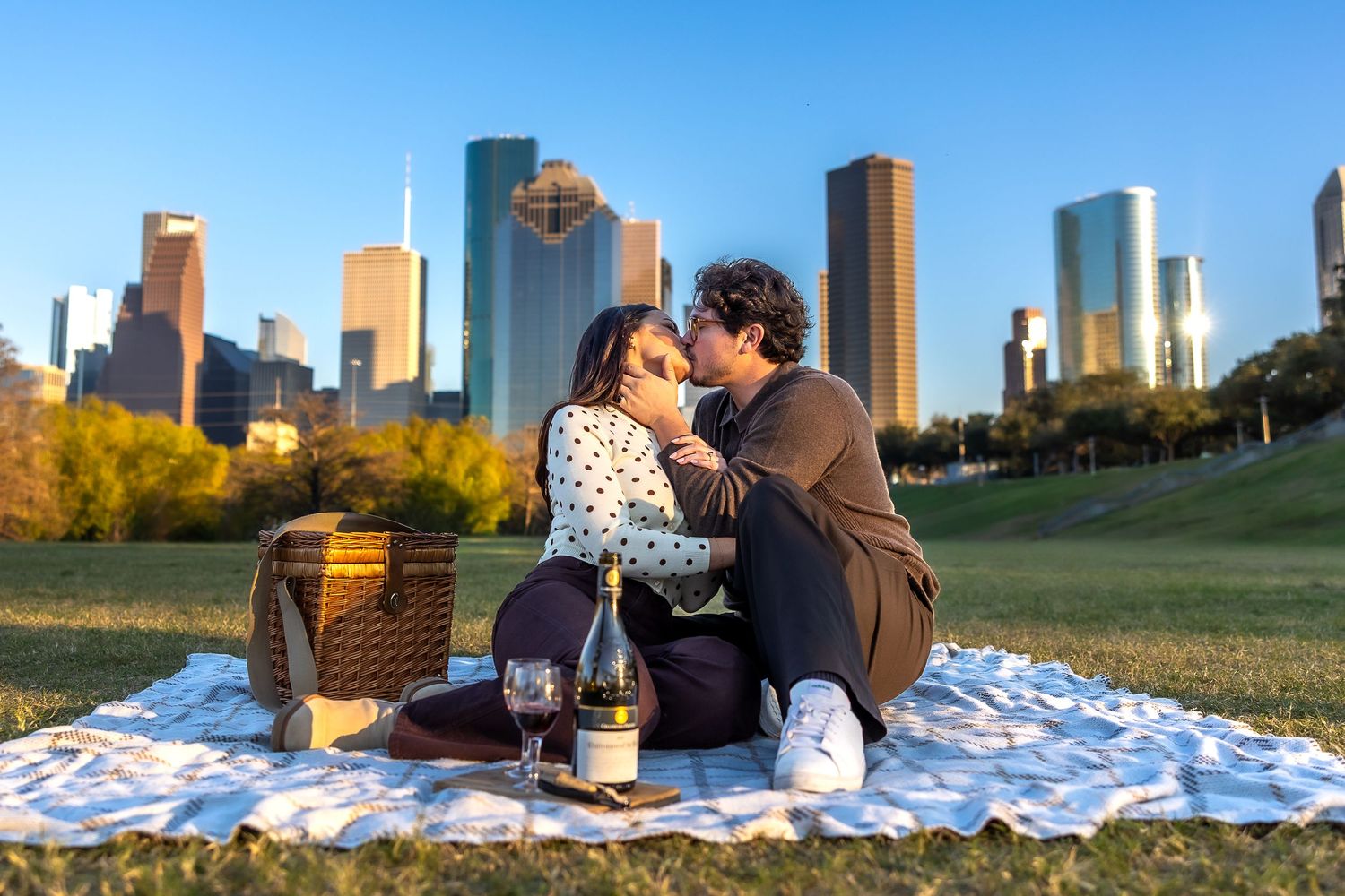 Picnic blanket spread out with city skyline view during golden hour.