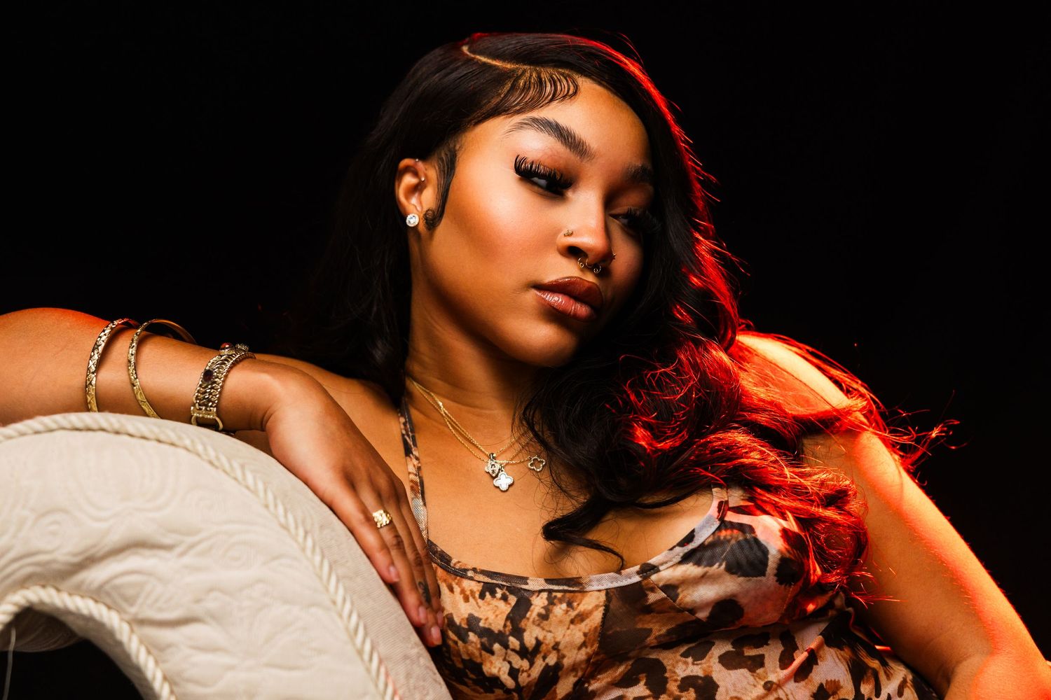 Dramatic boudoir portraits with red lighting against dark background.