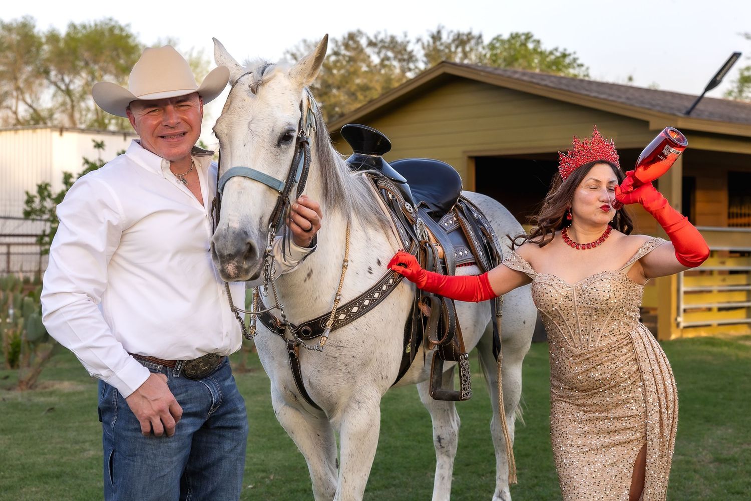 Western-themed photoshoot featuring people and horses in a rustic outdoor setting.