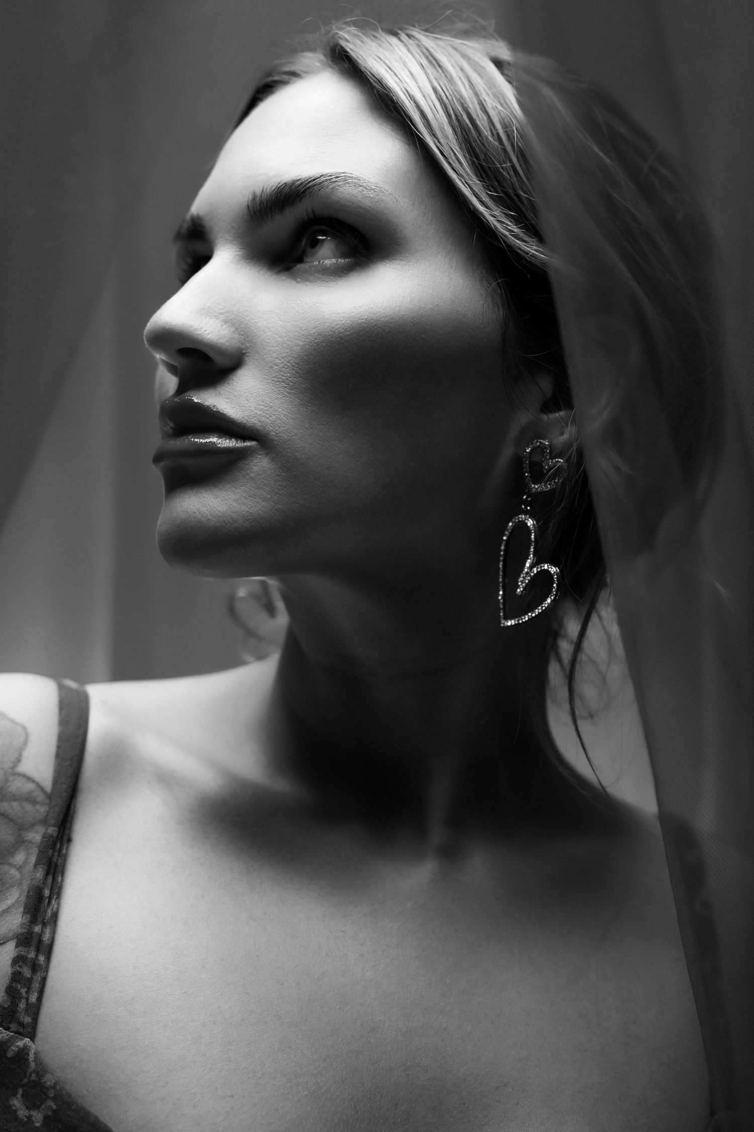 Artistic black and white profile portraits with dramatic side lighting.