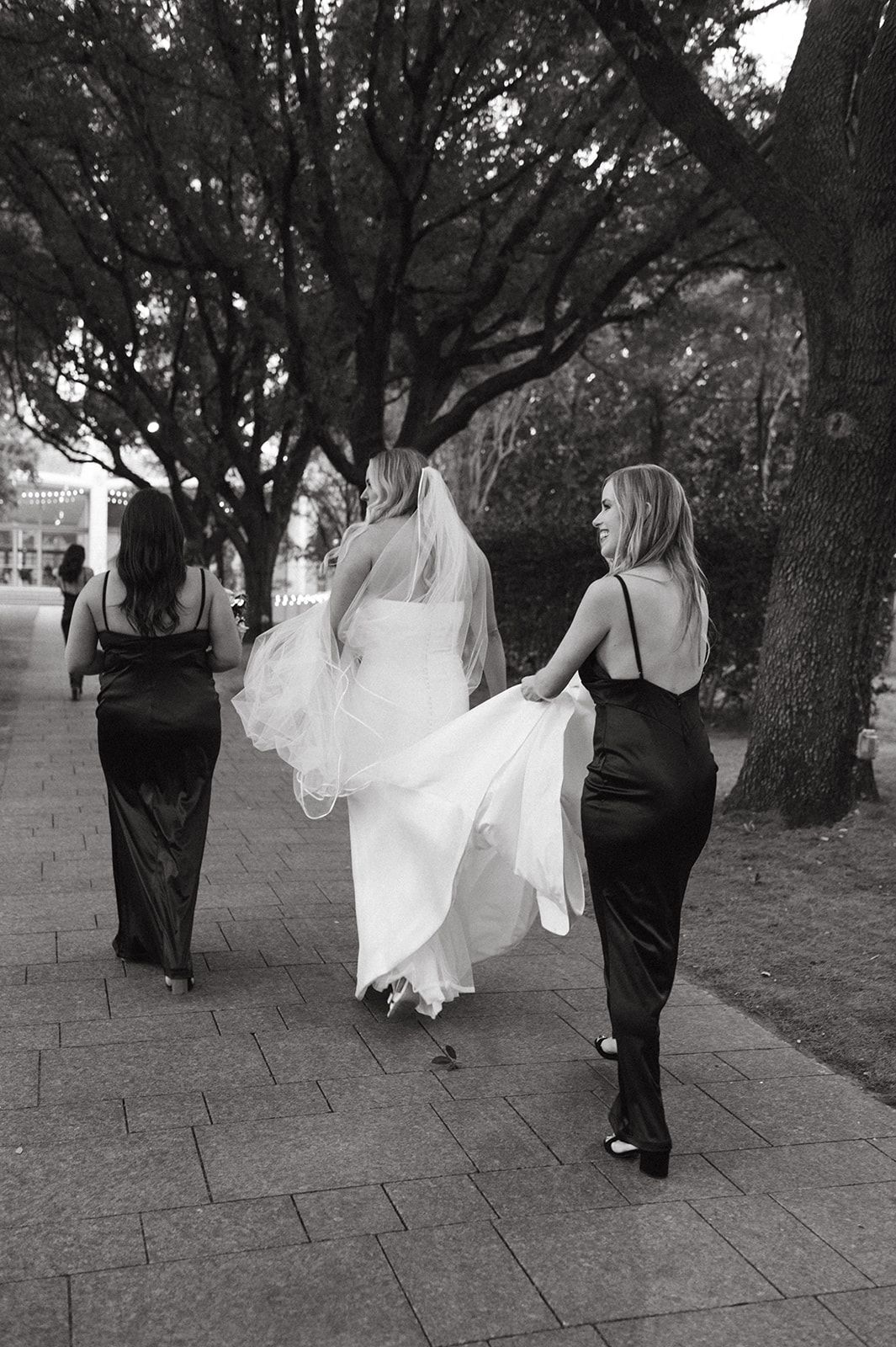 Bride and bridesmaids walking at the Nasher Sculpture Center.