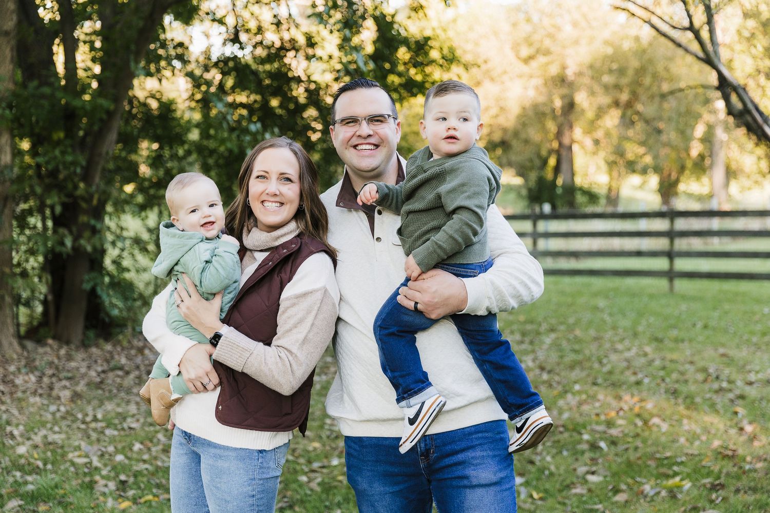 Family of four with two young children during a relaxed family photography session in Tipp City, Ohio.