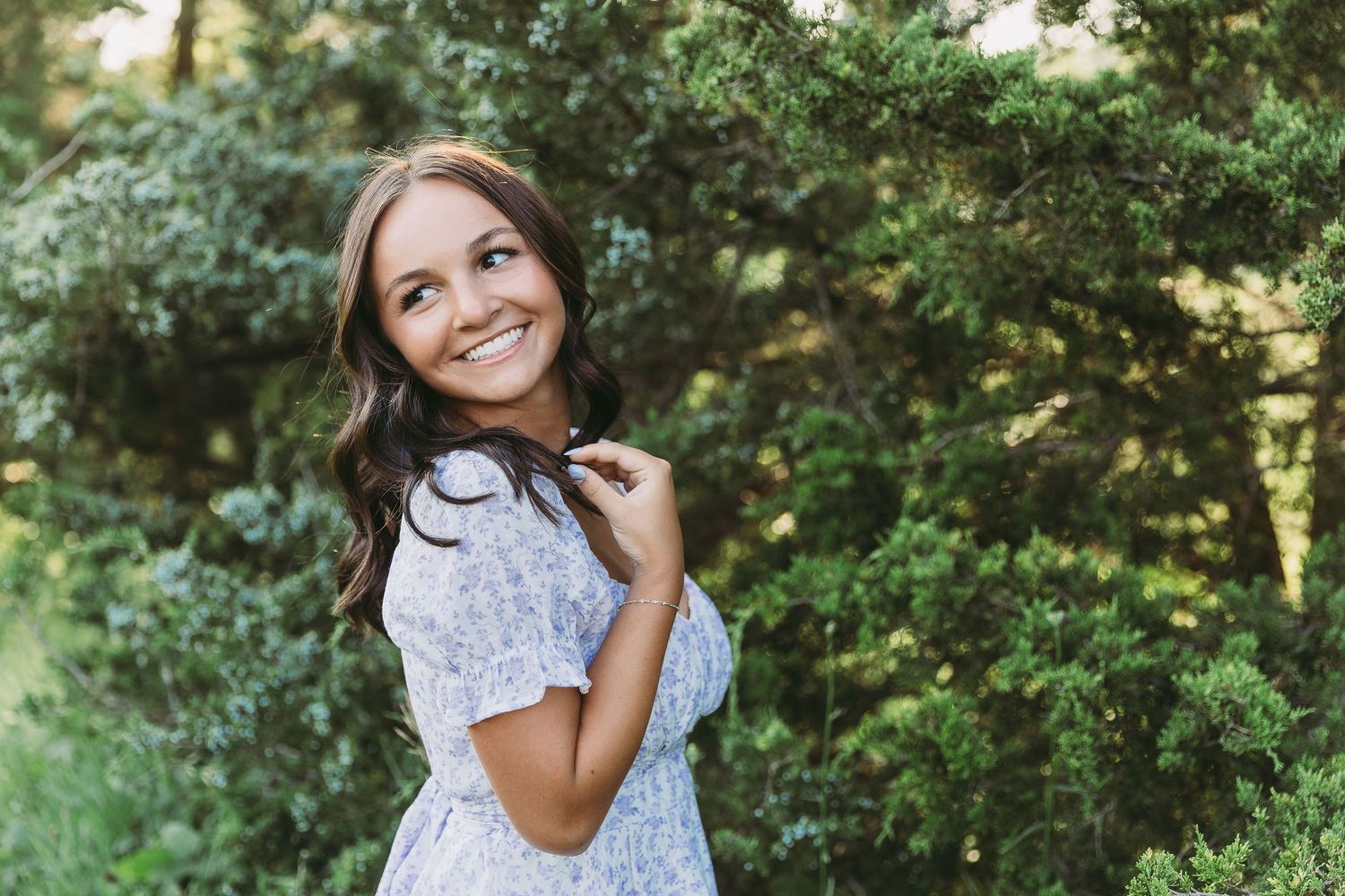 High school senior smiling outdoors during a senior photography session in Dayton, Ohio.