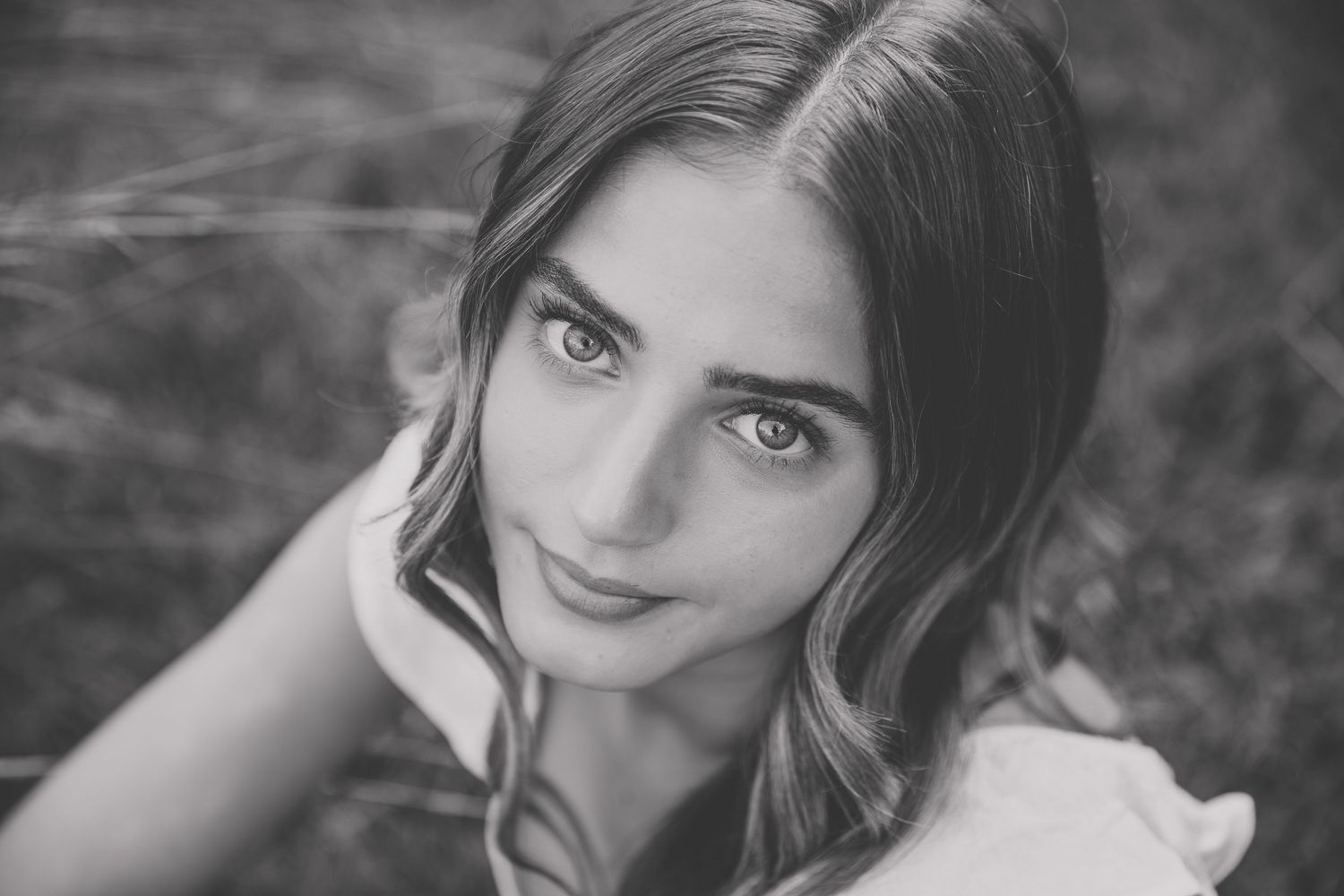 Black and white portrait of a young woman with long hair gazing upward outdoors, Katie Chamberlain Photography