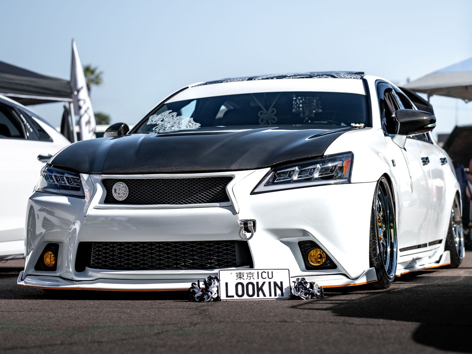 Customized white Lexus GS with wide body kit, low stance, and aggressive front bumper at Super Saturday Weekend at The STRAT in Las Vegas