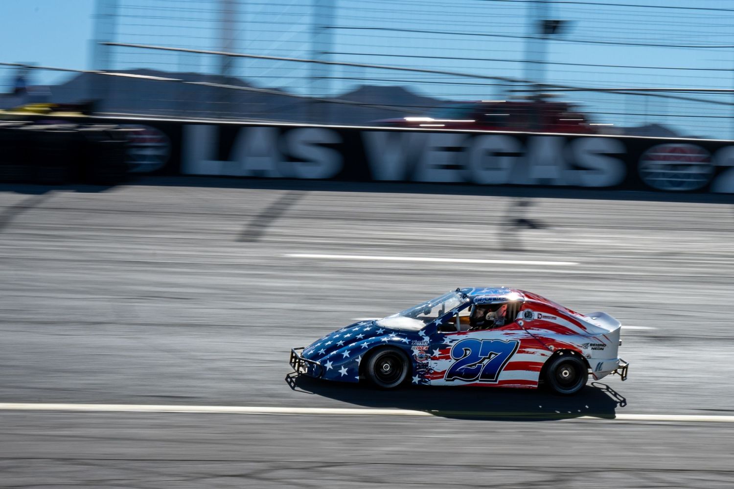 American flag themed bandolero car number 27 racing on Las Vegas Motor Speedway track.