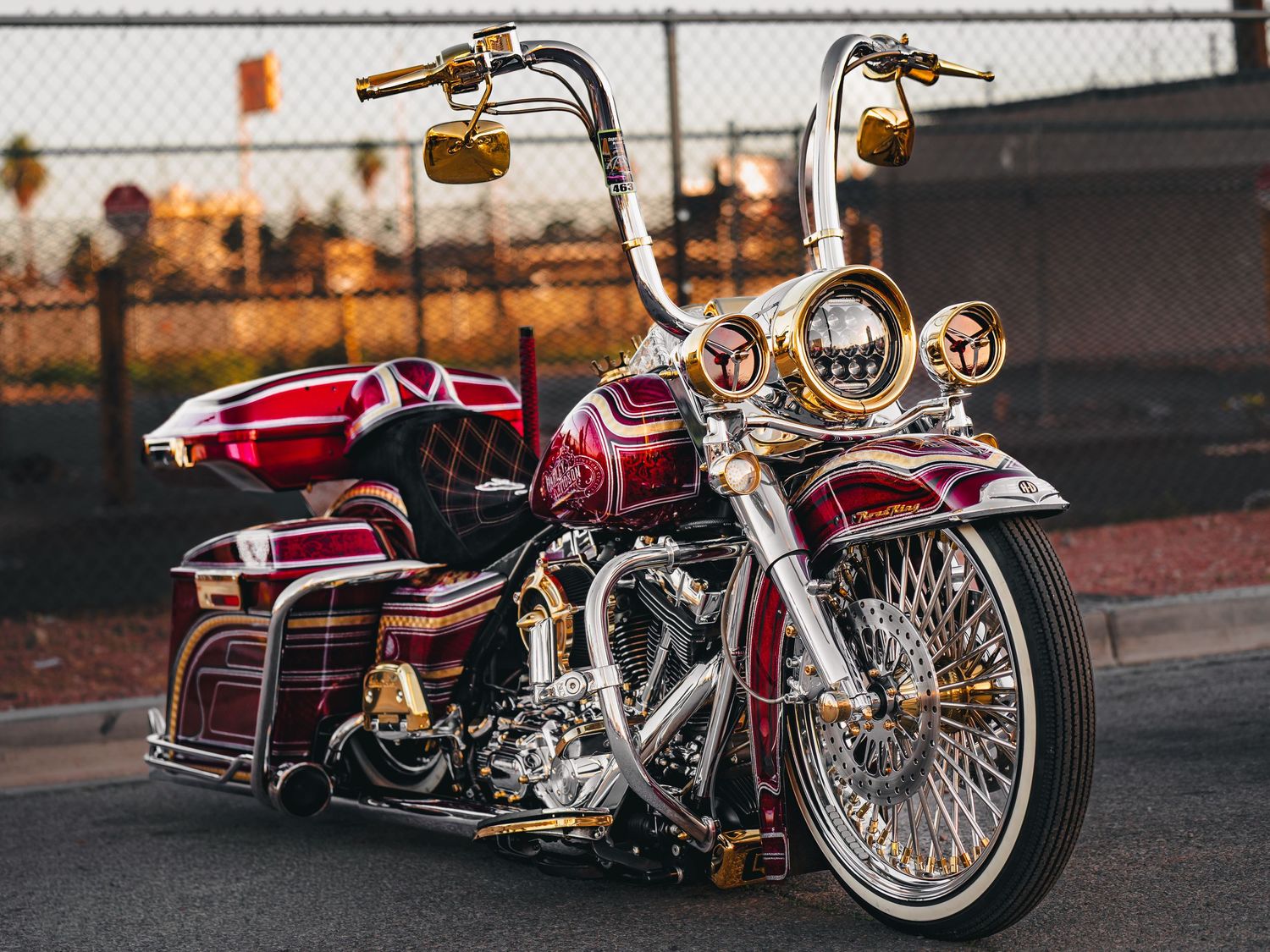 Stunning custom burgundy and gold Harley-Davidson lowrider motorcycle with chrome wire wheels at Super Saturday Weekend at The STRAT in Las