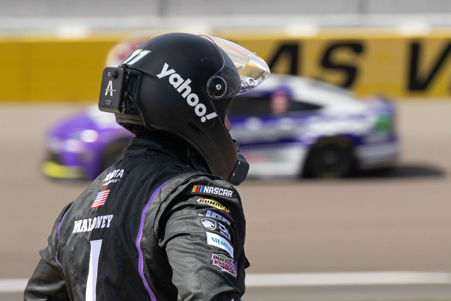 NASCAR crew member in Yahoo! sponsored gear watches race action at Las Vegas Motor Speedway.