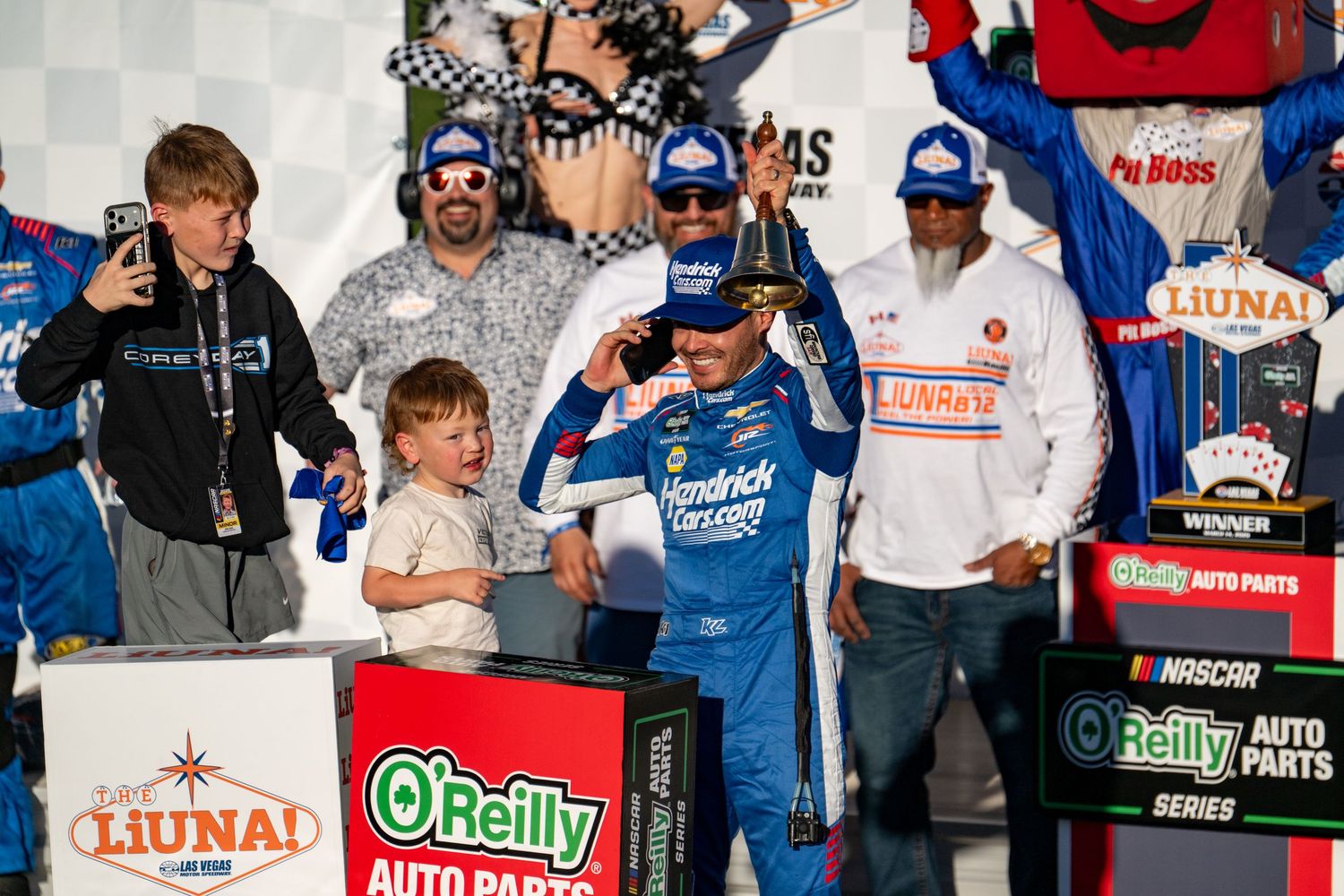 NASCAR winner celebrating in Victory Lane with trophy at O'Reilly Auto Parts Hendrick Motorsports event.