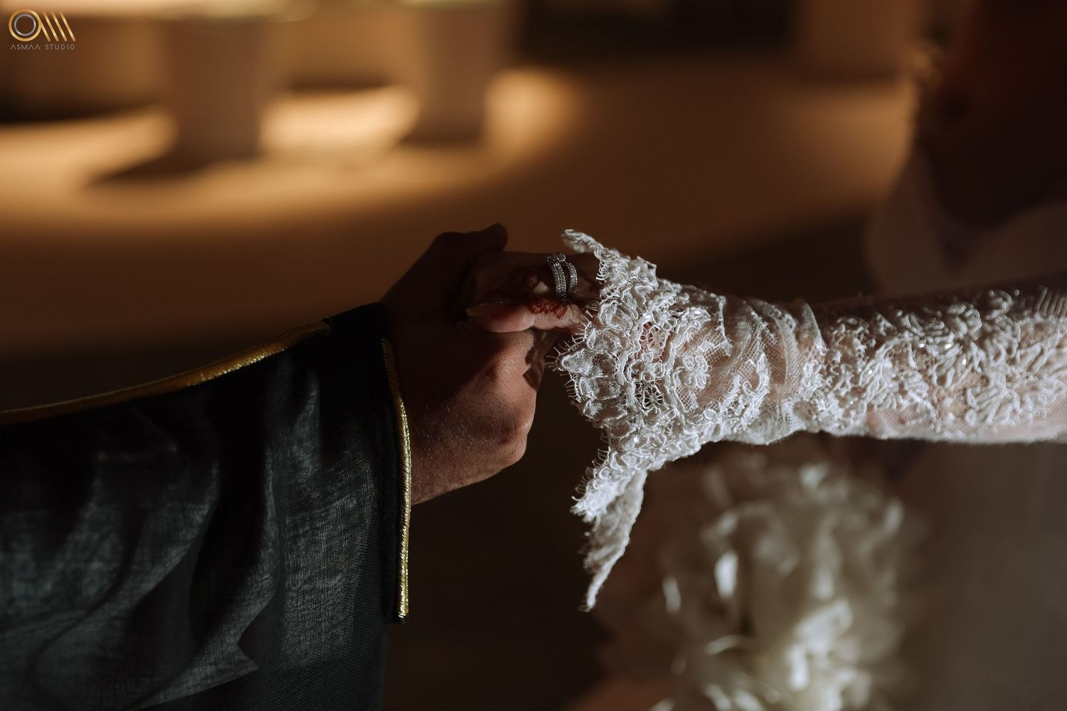 Close-up detail of intricate lace wedding dress beading and embellishments.