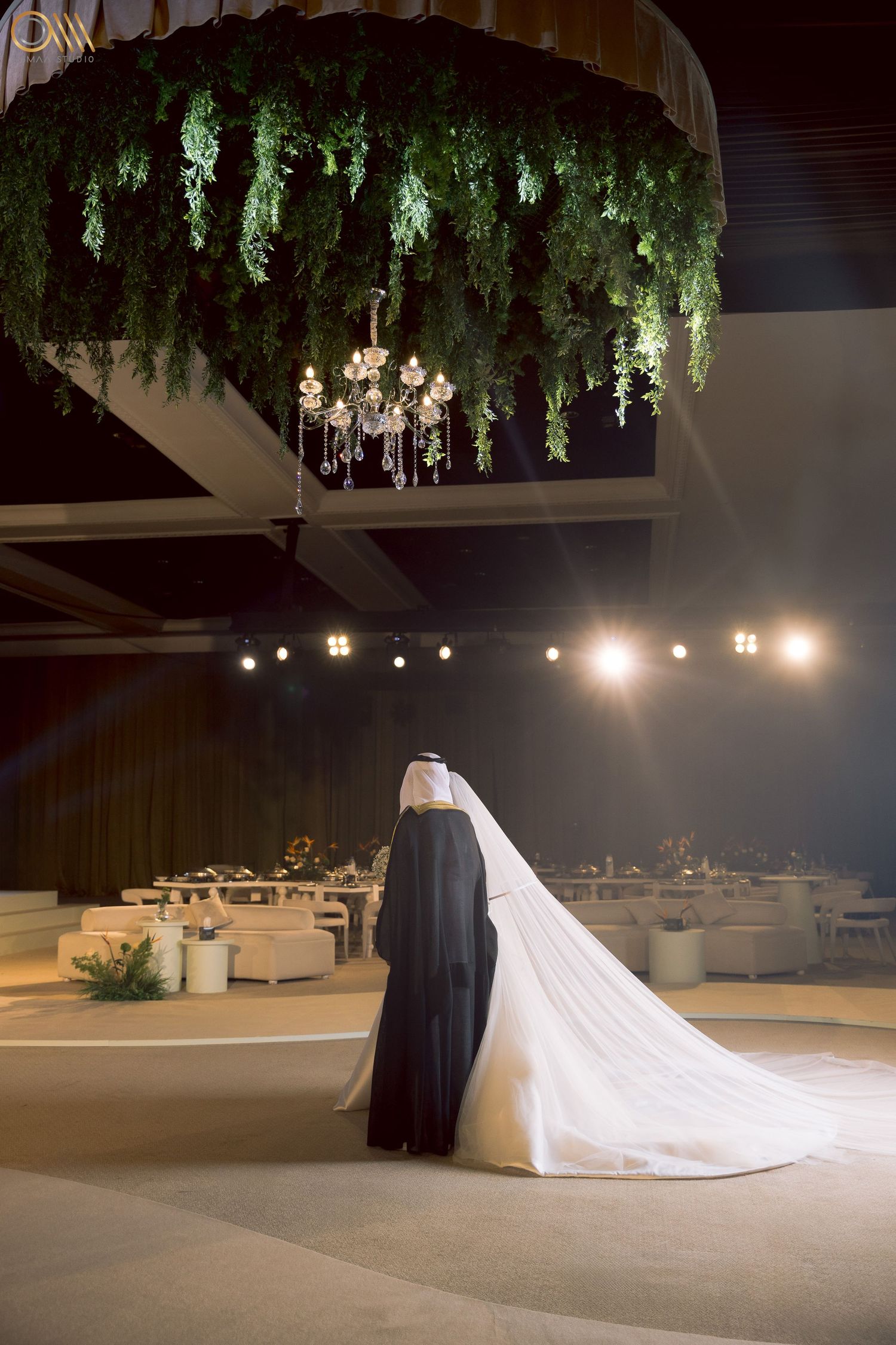 A dramatic wedding photo sequence showing a flowing white dress train in a dimly lit venue with hanging greenery.