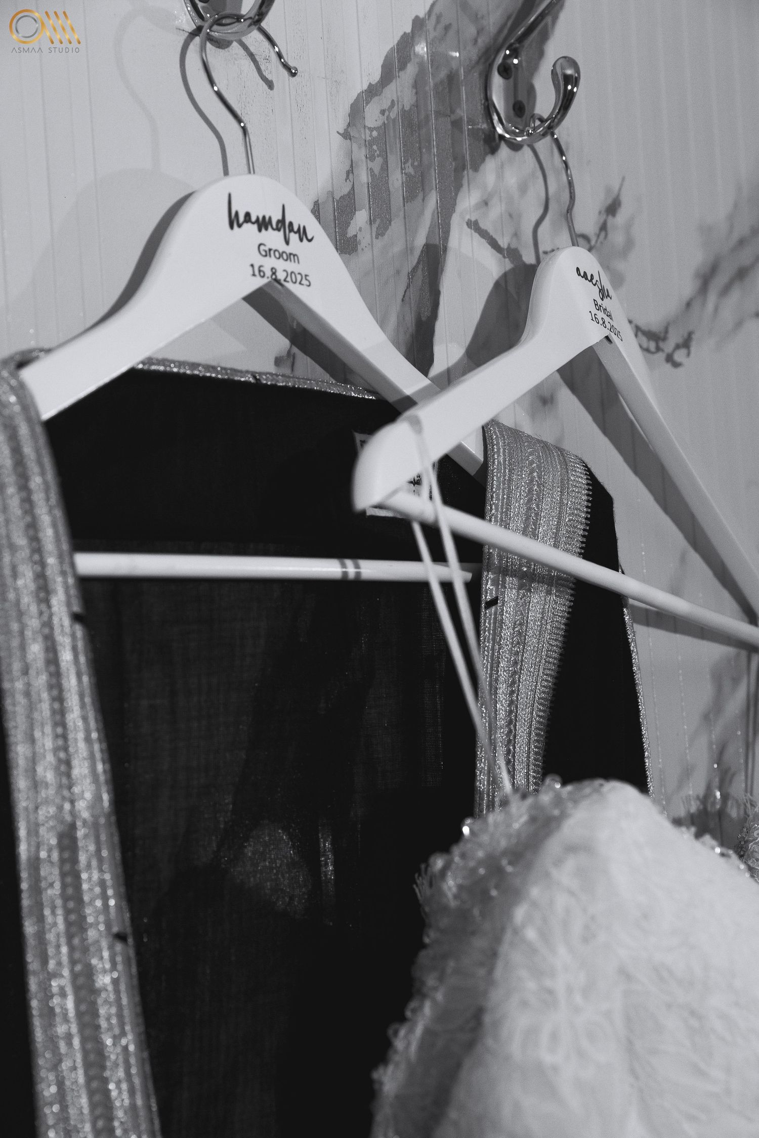 Wedding dresses hanging on display with sparkly sequined details in black and white.