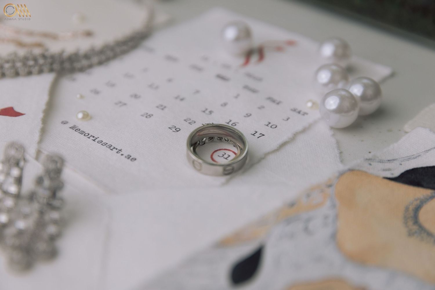 Bridal accessories and stationery featuring pearl necklaces and elegant paper designs.