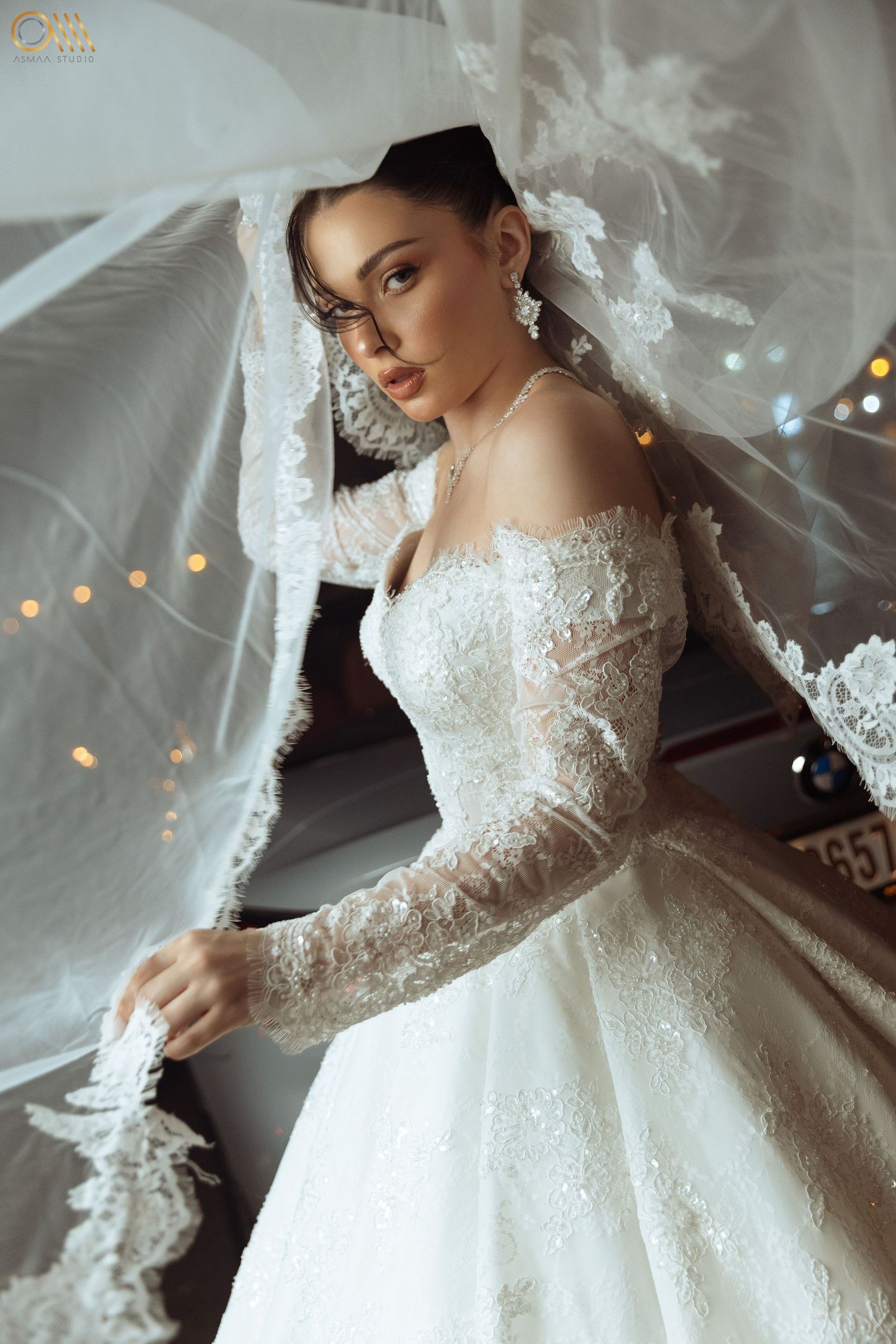Romantic bridal portrait showcasing an off-shoulder lace wedding dress with delicate details.