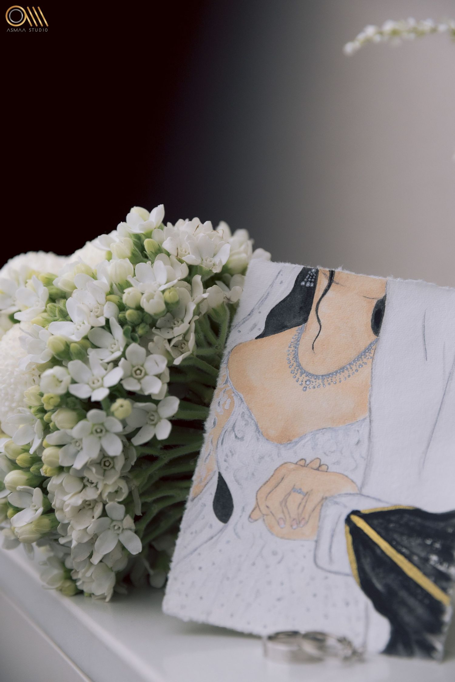 White flowers and wedding stationery with navy and peach design elements on a light surface.