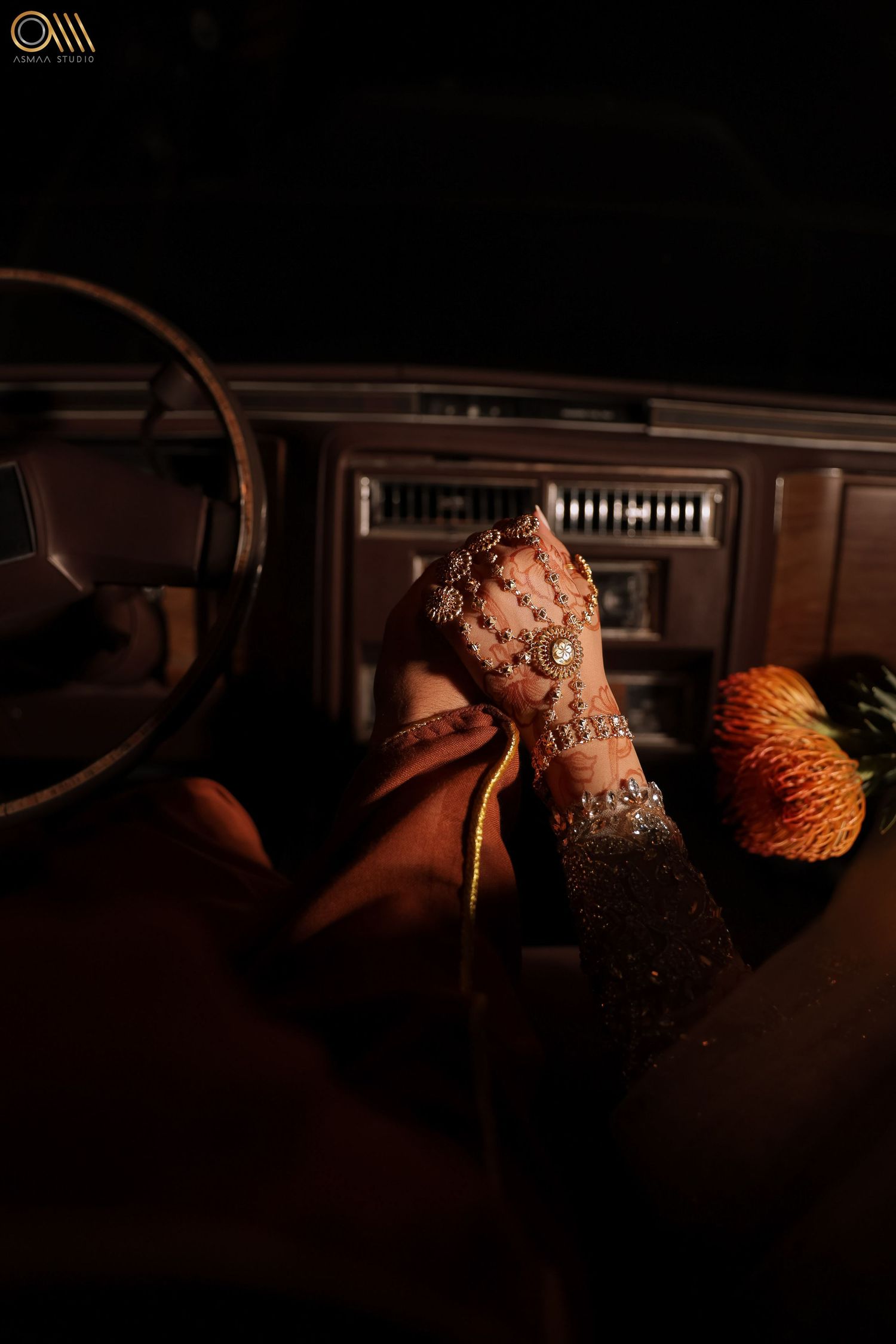 Artistic low-light photography of wedding dress details with warm lighting.
