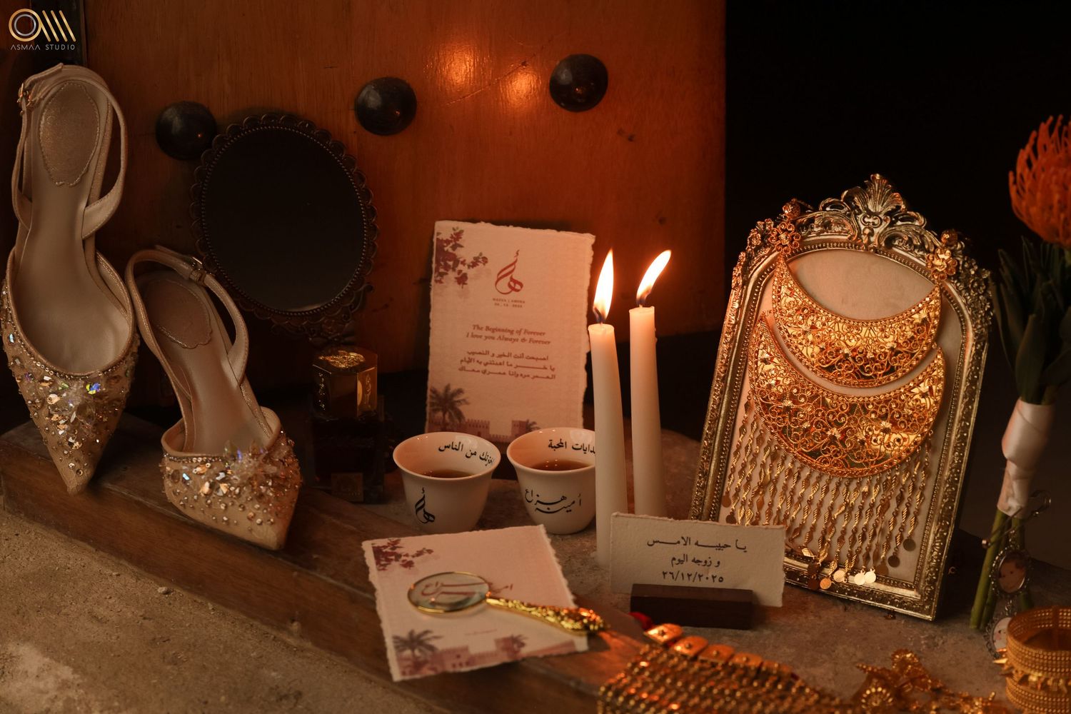 Elegant wedding accessories including embellished shoes and invitation cards in candlelight.