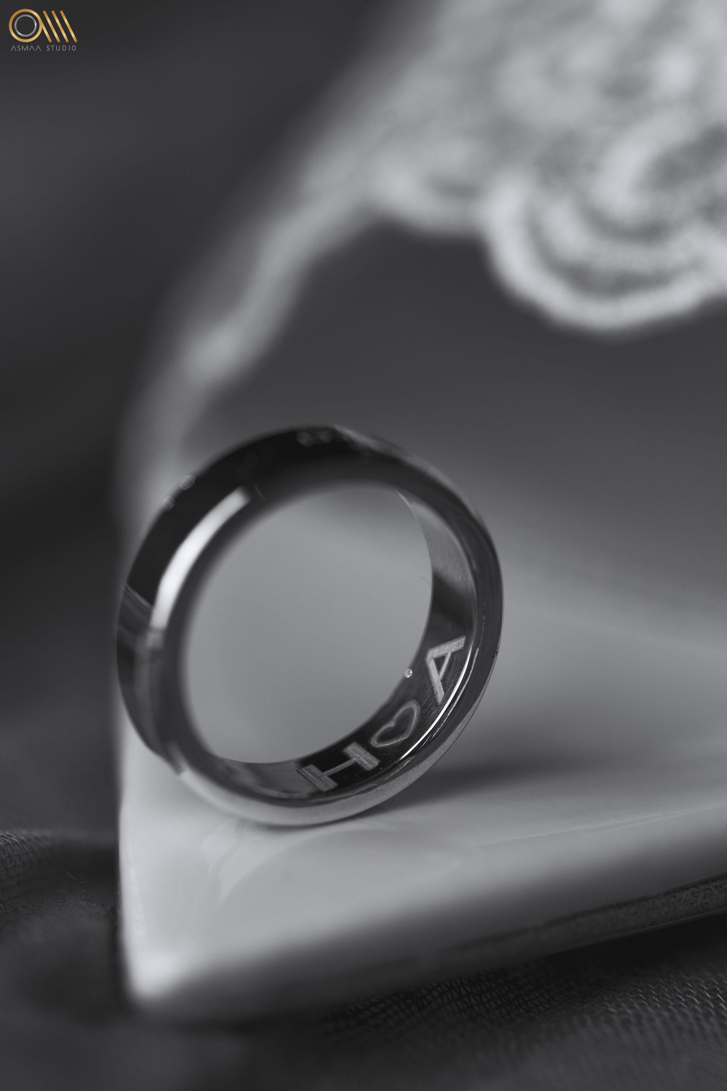 Wedding ring macro photography with artistic shadow and reflection.