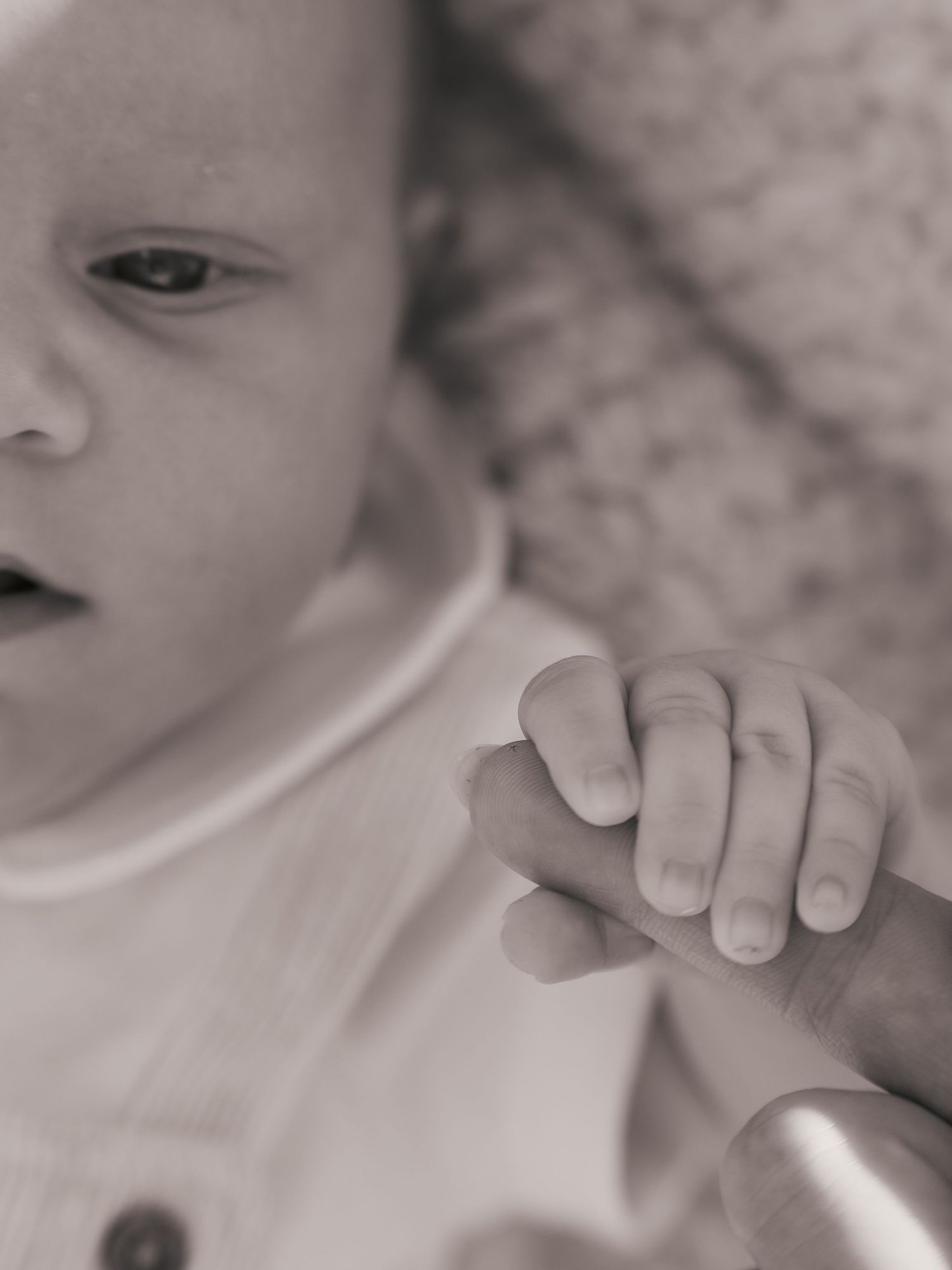Hands gripping mums finger