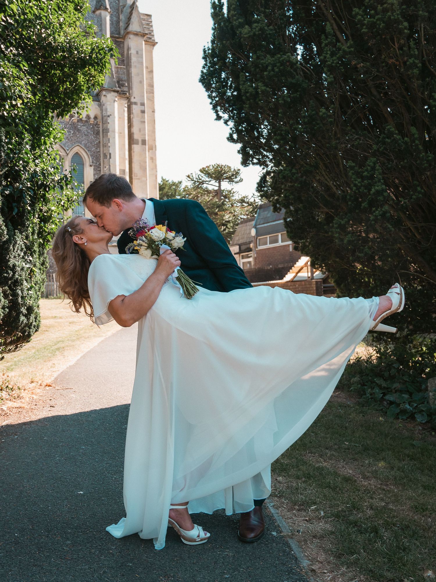 Wedding dip shot outside church