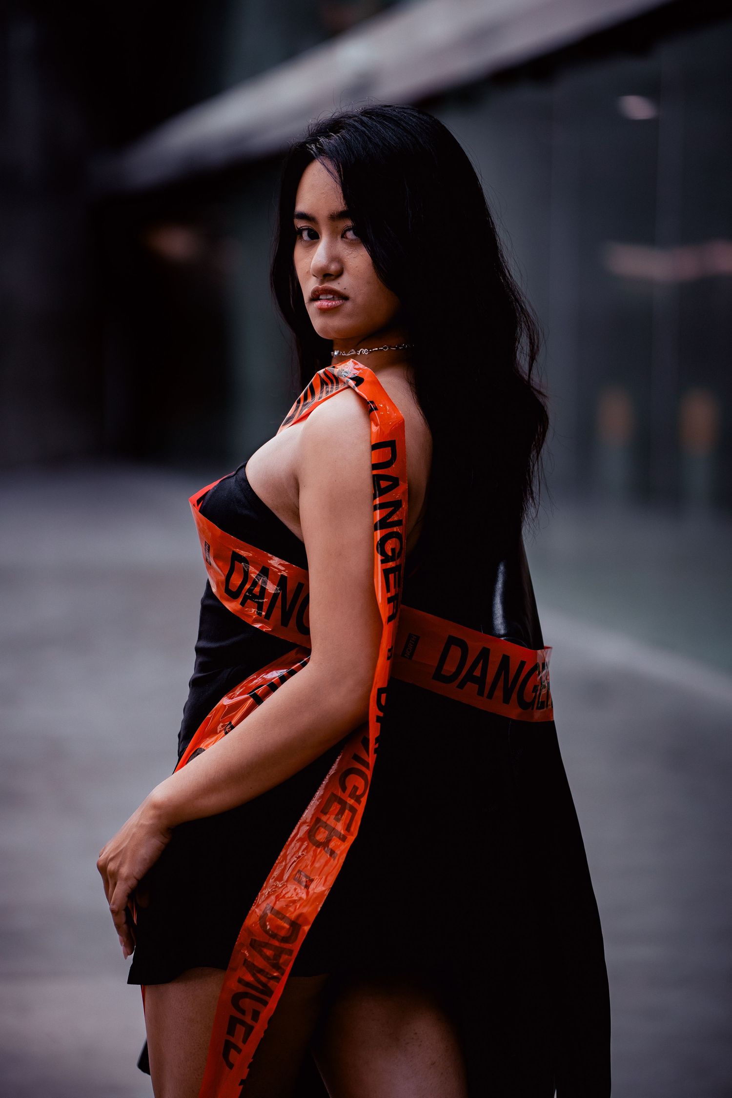 Artistic portrait series featuring orange and black tones in an urban setting.