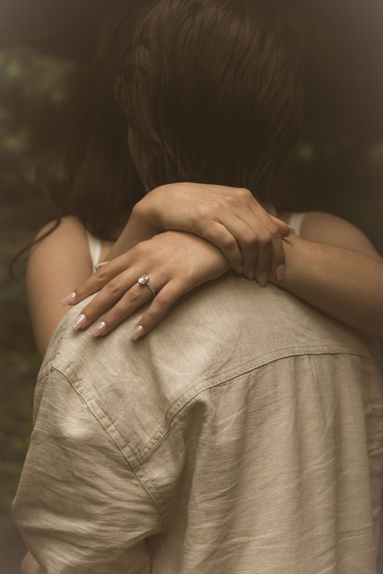 Close-up series of hands gently resting on shoulders in soft lighting.