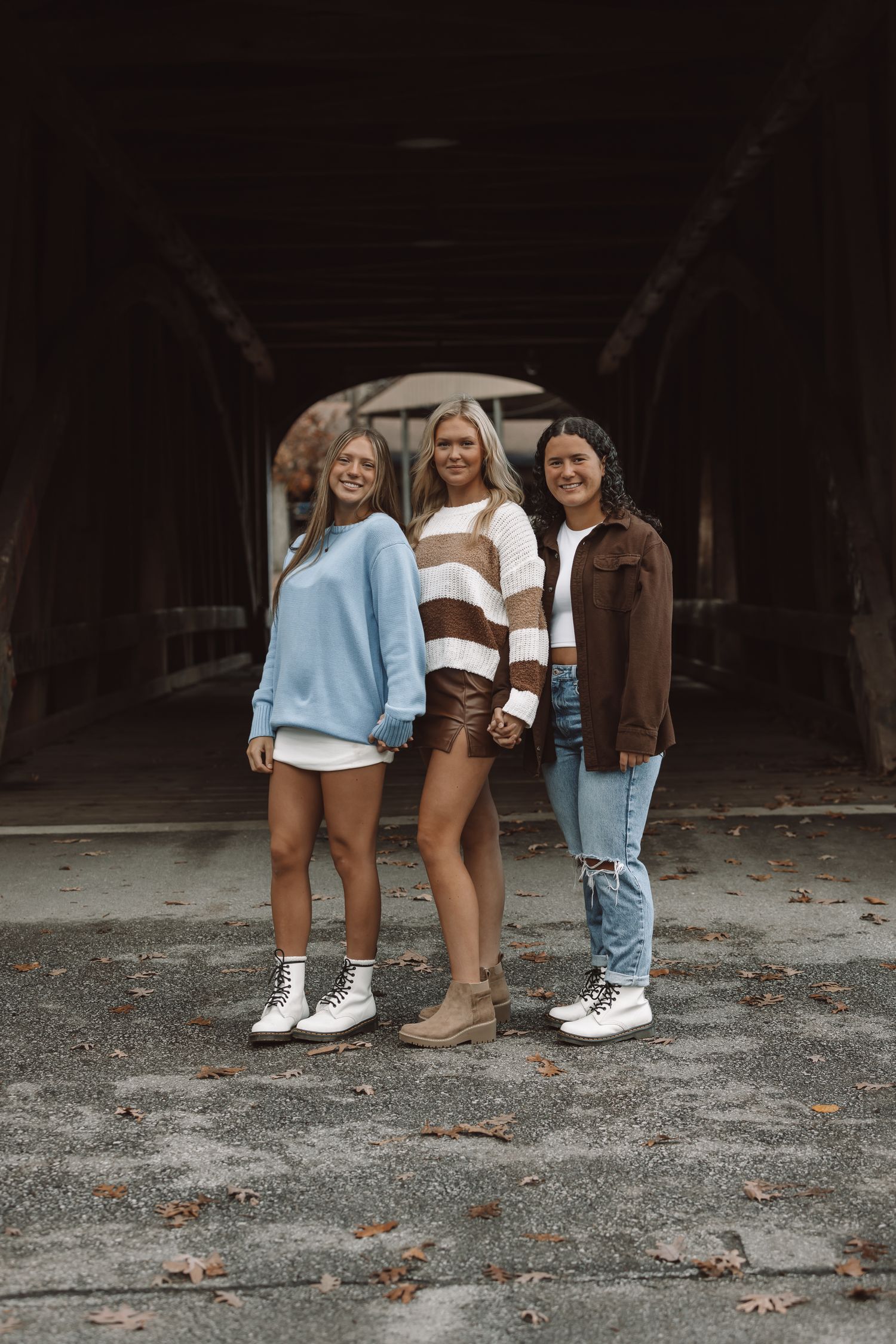 Creative photo of legs and feet of friends standing in casual wear.