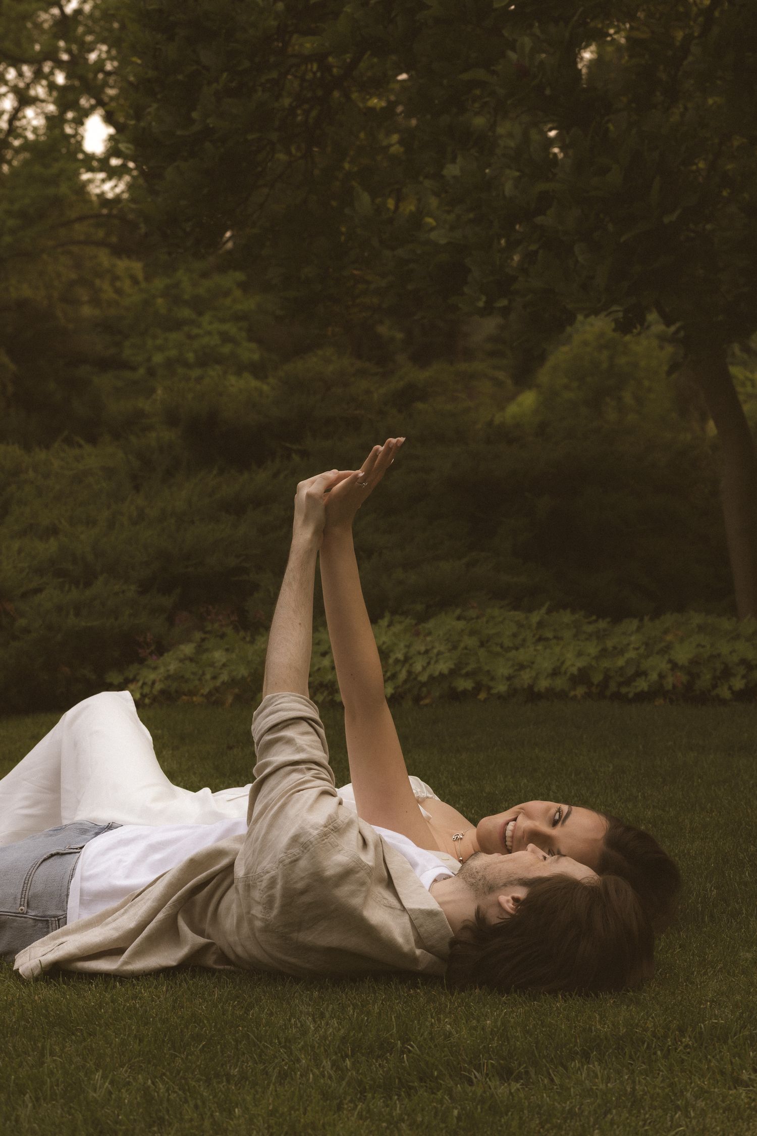 Artistic photo series of people lying in grass at sunset.