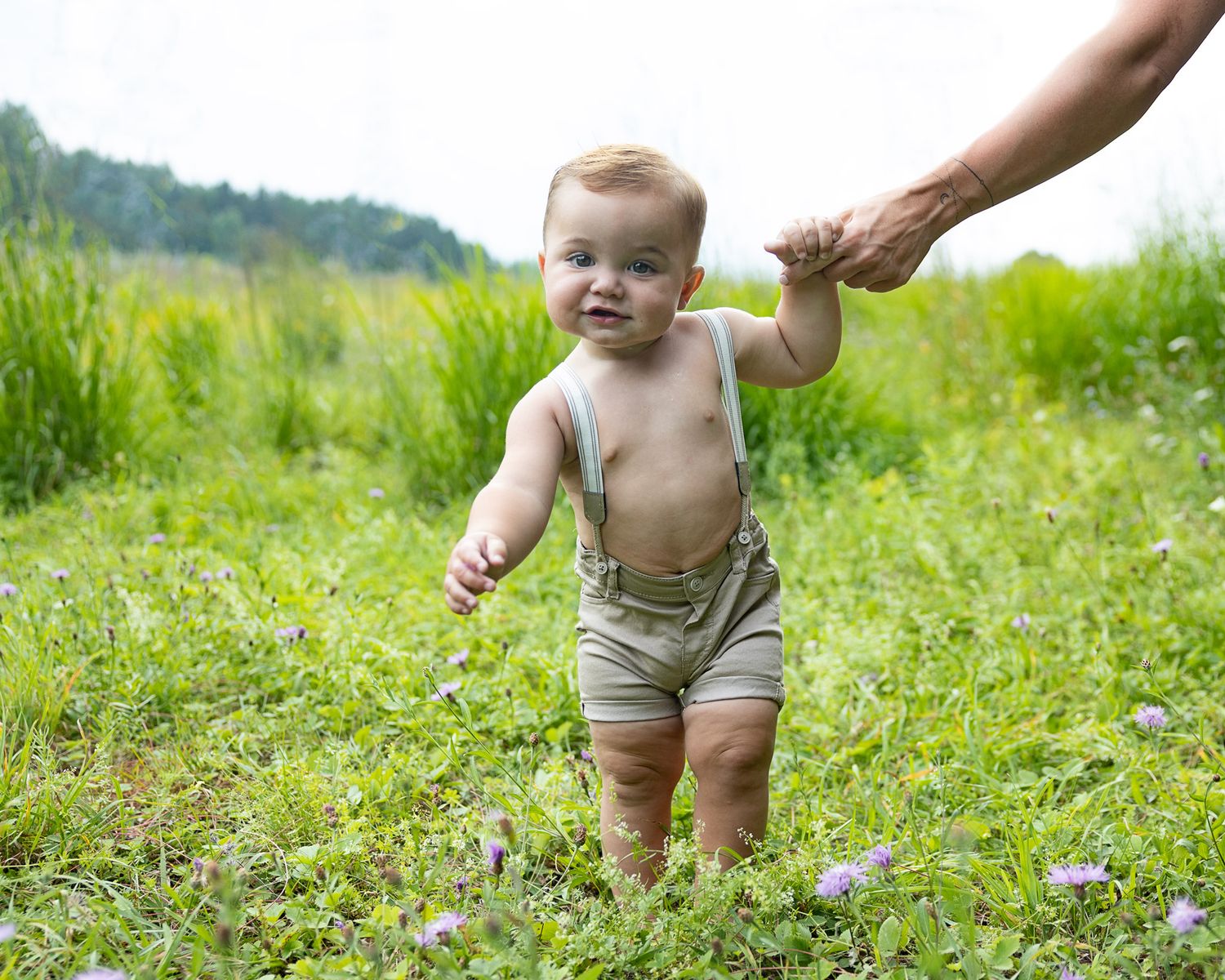 a young child holding his mothers hand during a mommy and me session in Allan park, west grey.