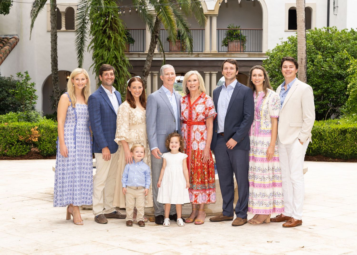 A family of 10, posed and smiling at the camera.