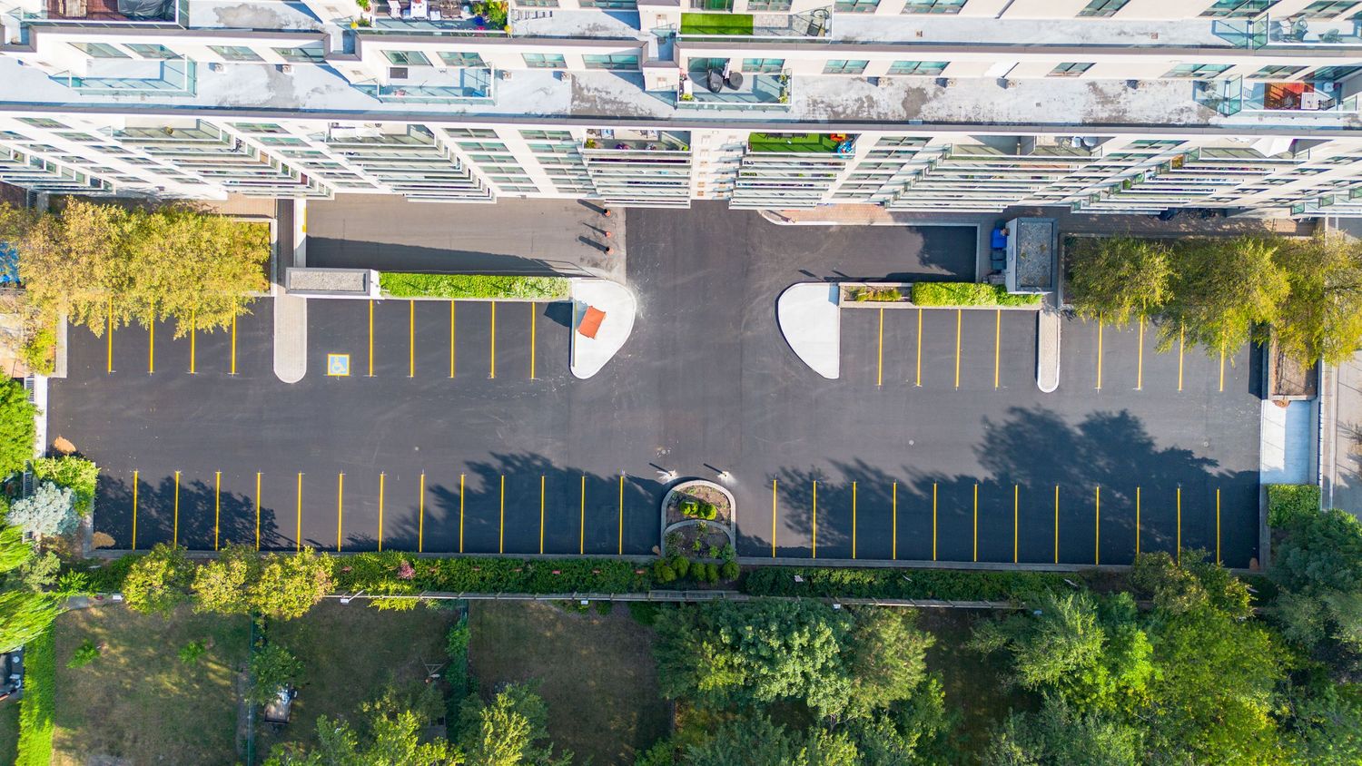 Aerial view of a large warehouse or distribution center with multiple loading docks and parked trucks.